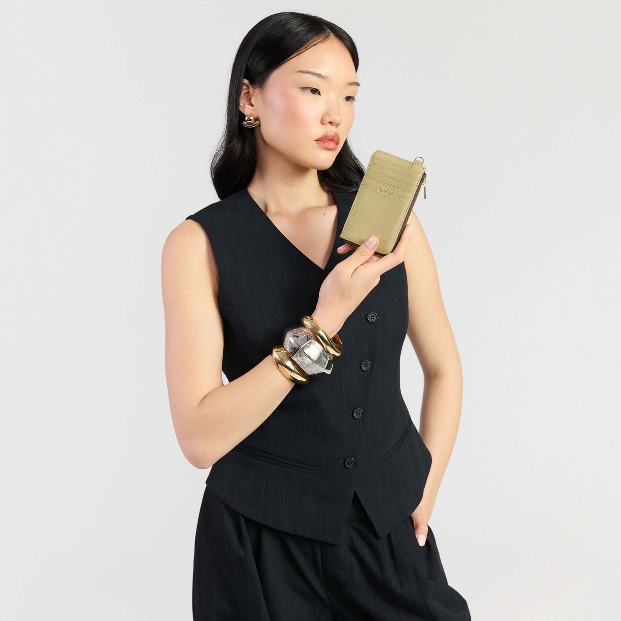 Model showcasing Saben Winona Card Holder - Willow in premium textured leather, styled with a chic outfit.