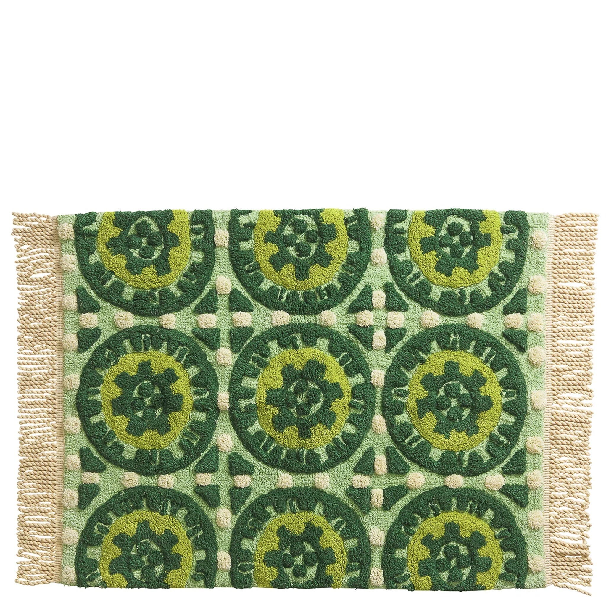 Green and beige patterned bath mat with circular designs on a white background