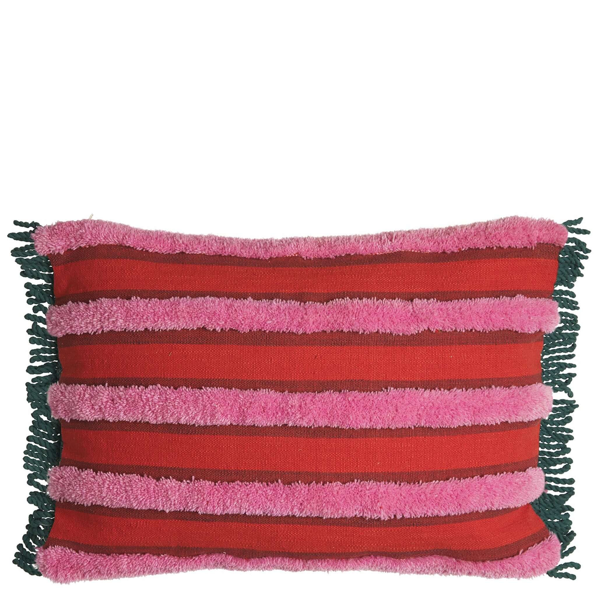 A rectangular tufted cushion with red and pink stripes and green fringe edges.