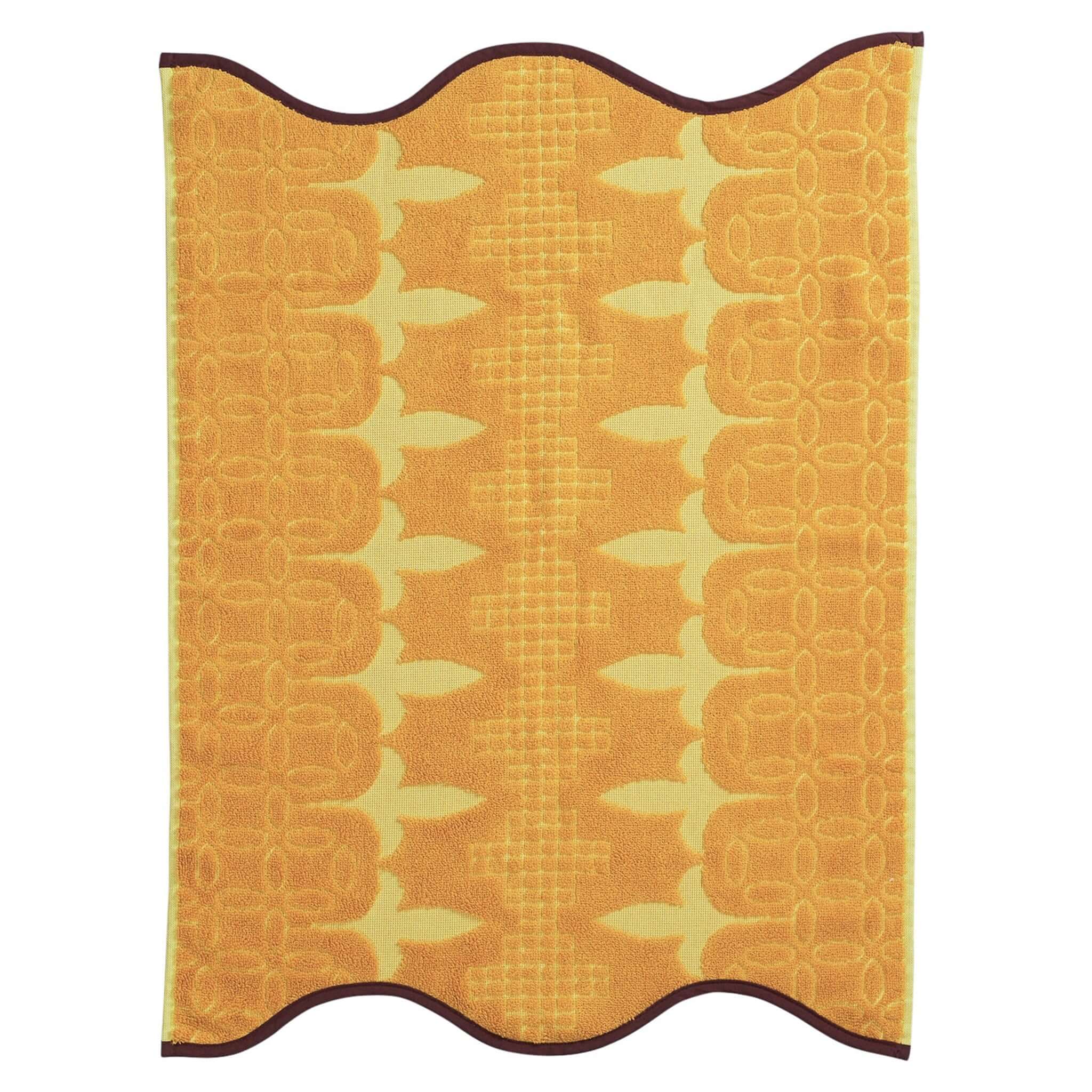 Yellow textured hand towel with leaf pattern on a white background