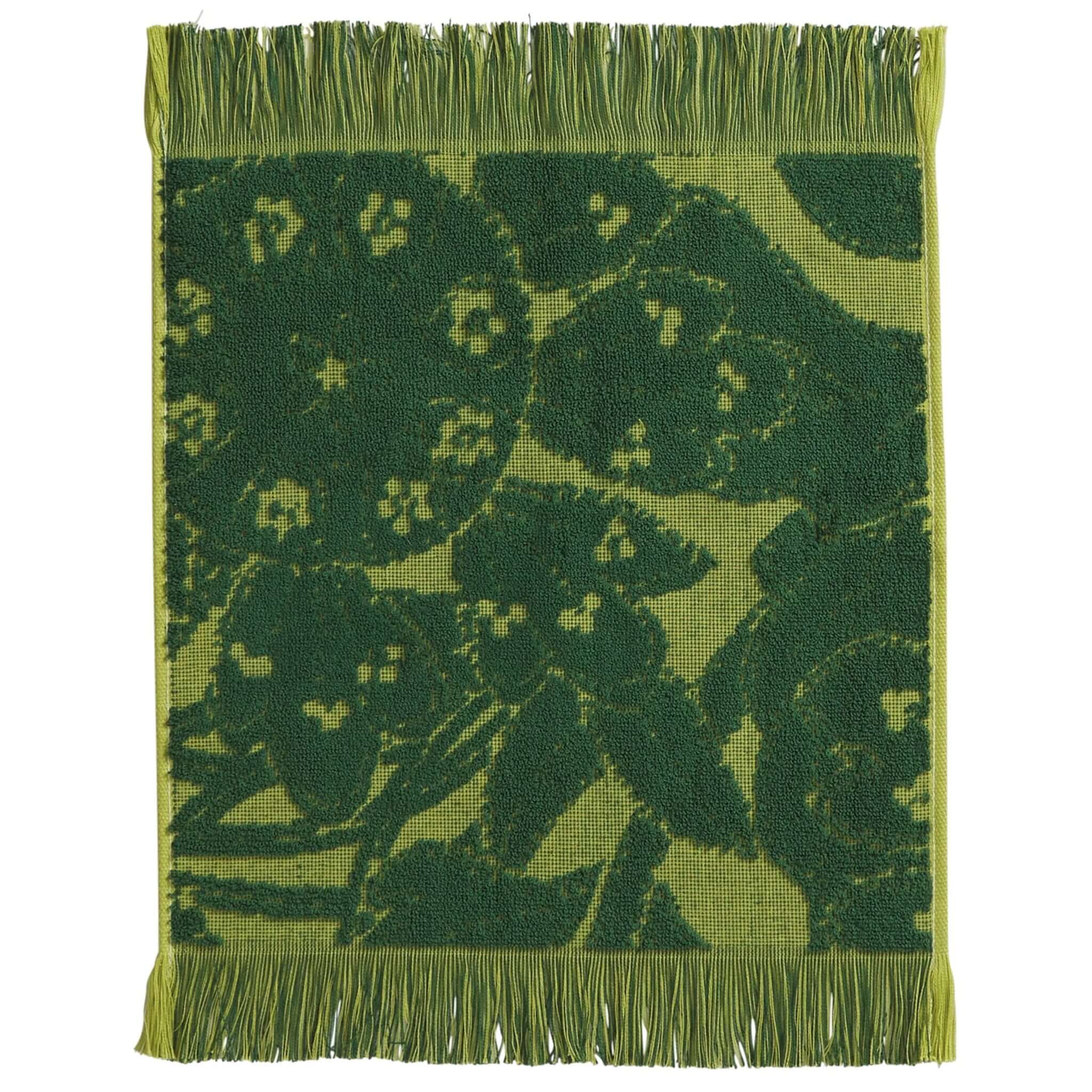 Green woven wash cloth with floral pattern on a white background