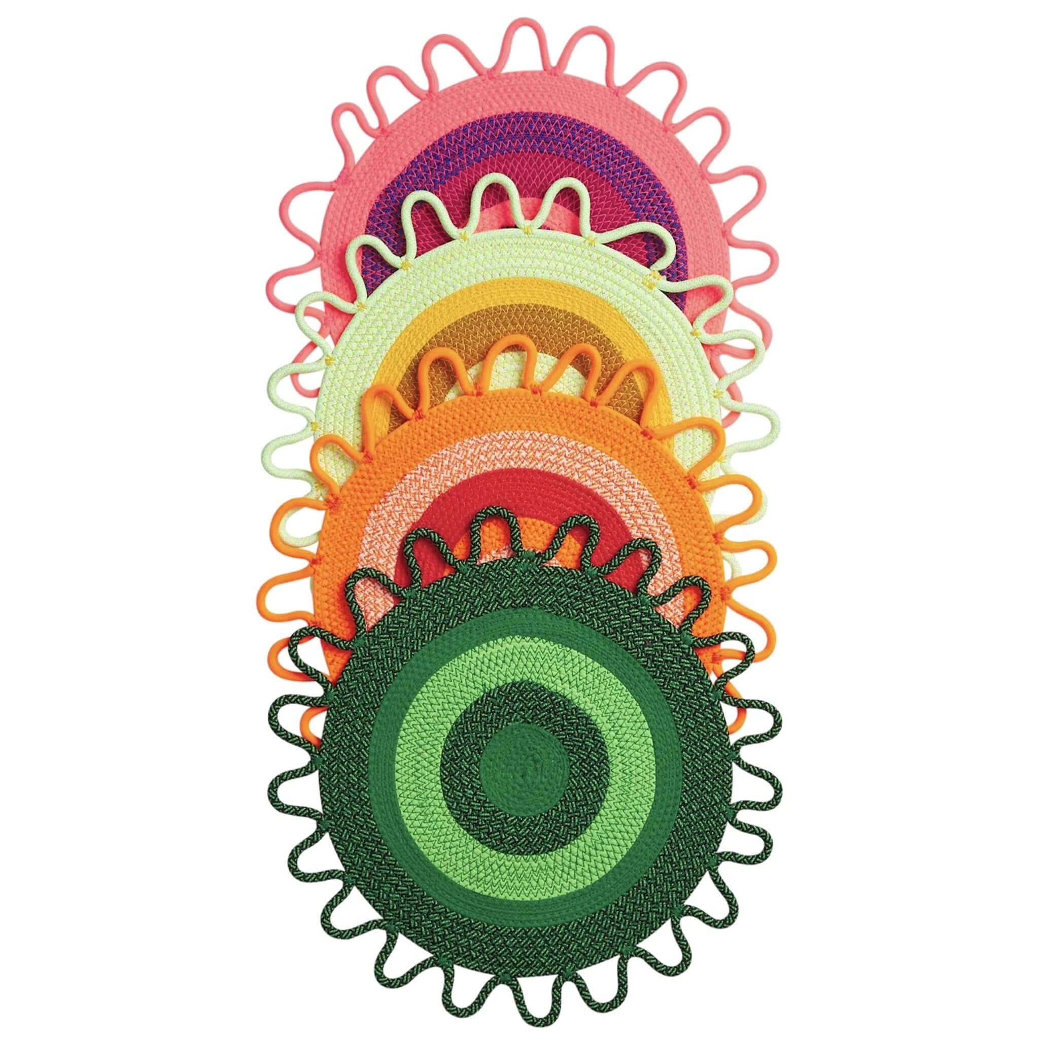 Colorful circular placemats with decorative edges on a white background