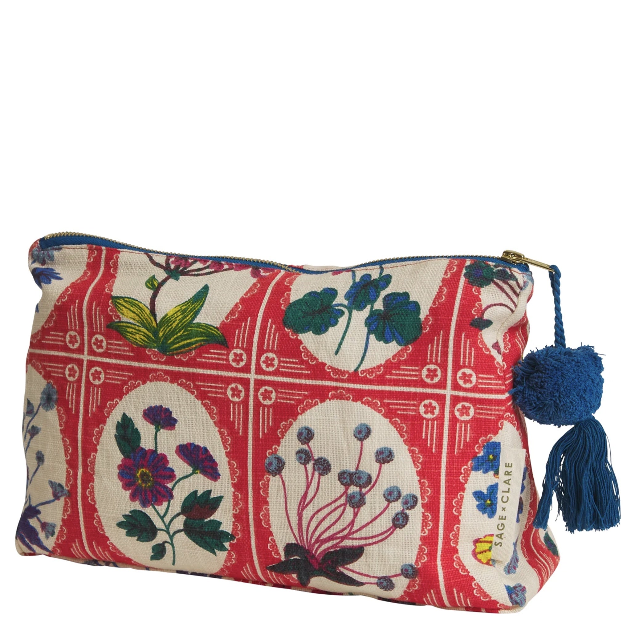 A red and multicolored floral print organic cotton cosmetic bag with a tassel zipper pull.