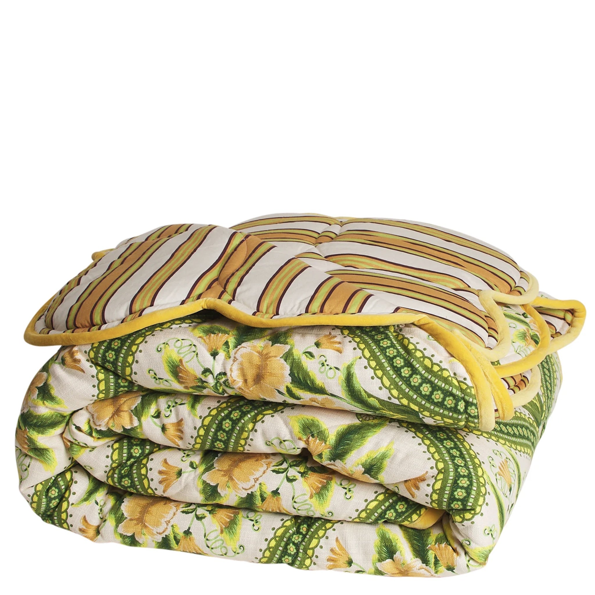 Folded floral patterned quilt with yellow trim on a white background