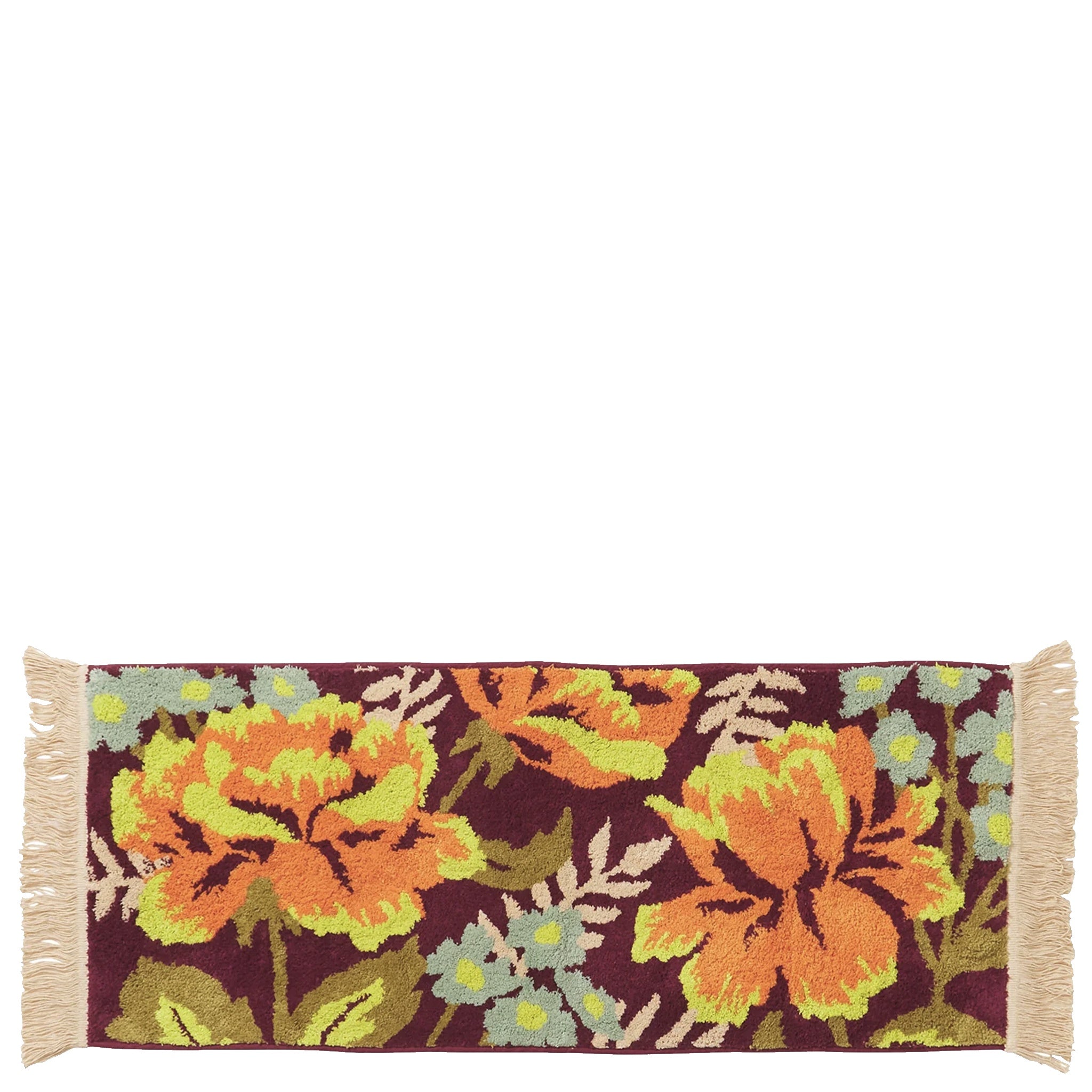 Floral patterned bath mat with tassels on a white background