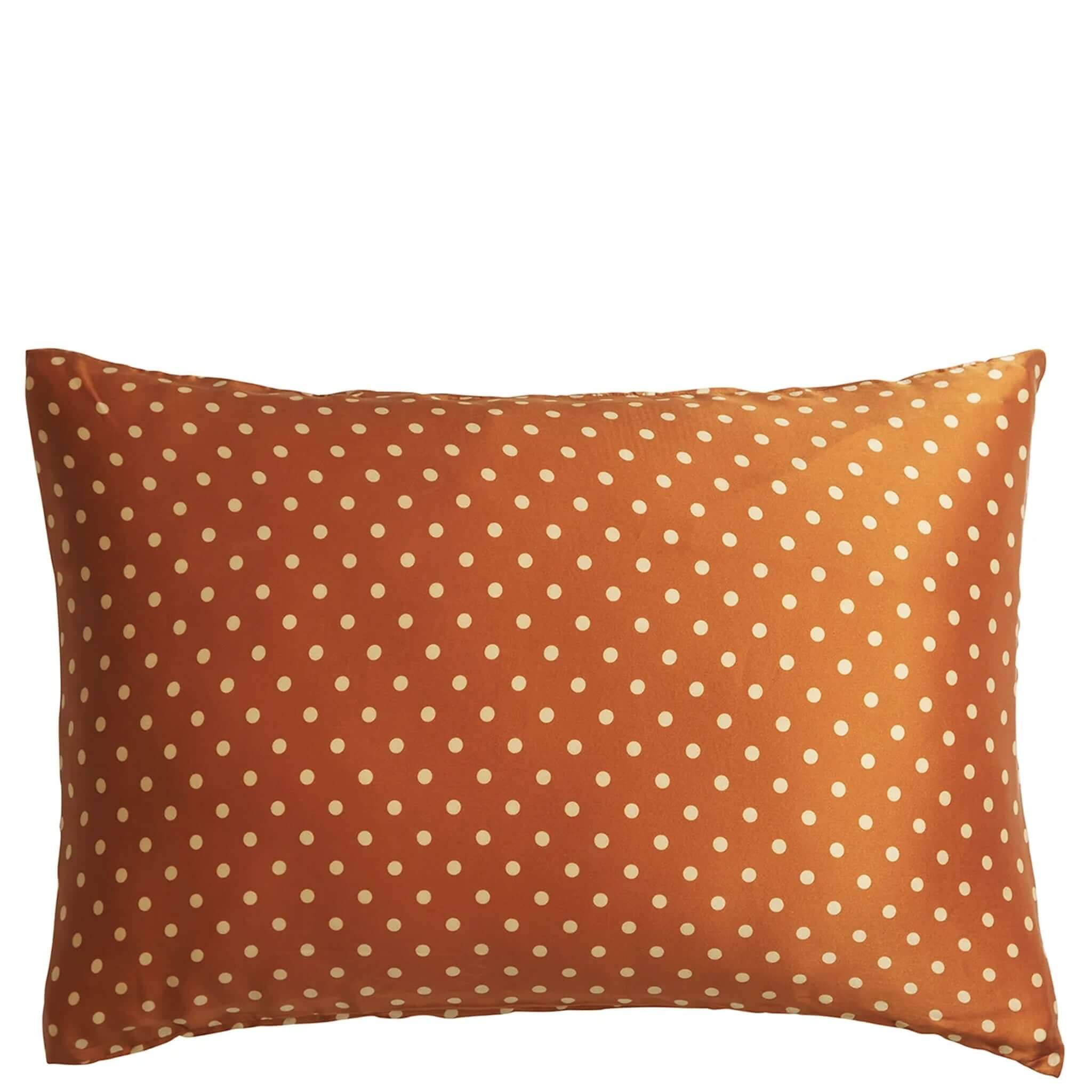 A copper-colored silk pillowcase with a polka dot pattern.
