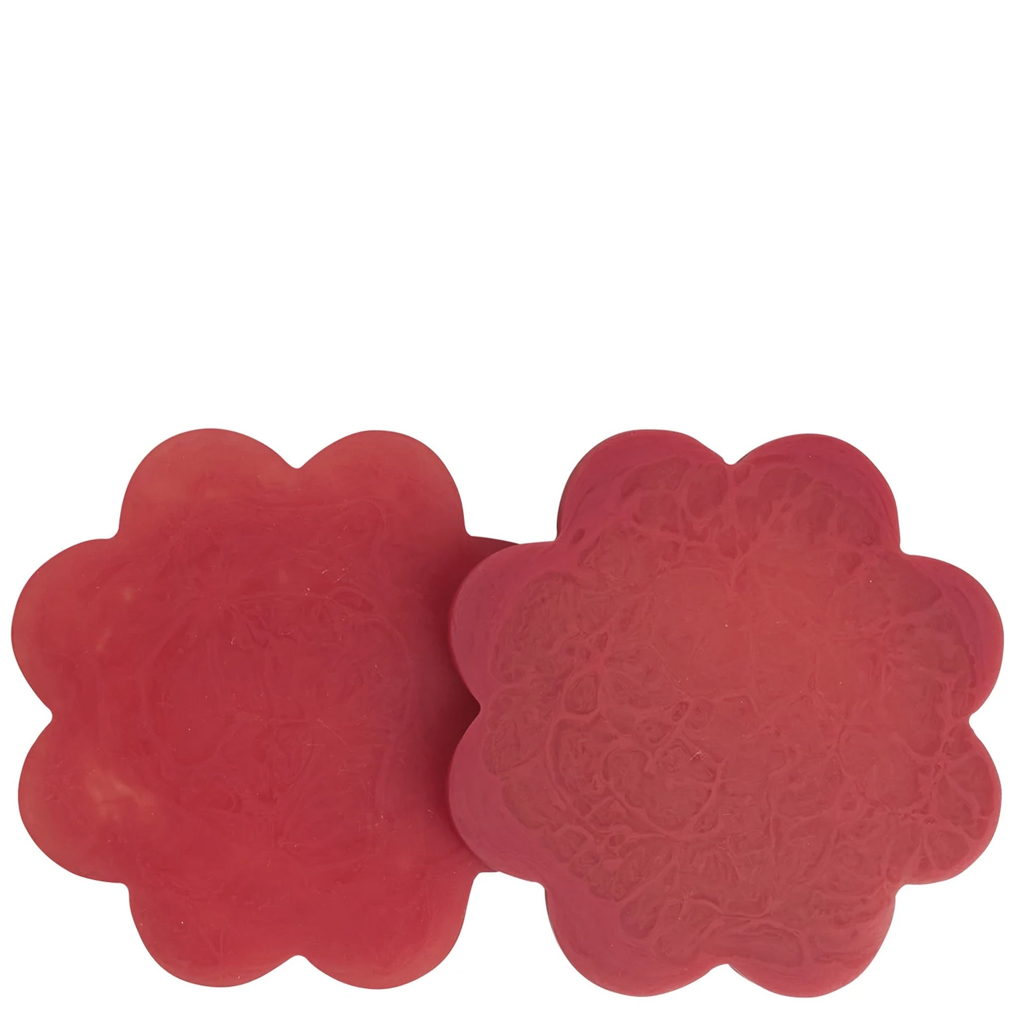 A set of two red floral resin coasters with scalloped edges.
