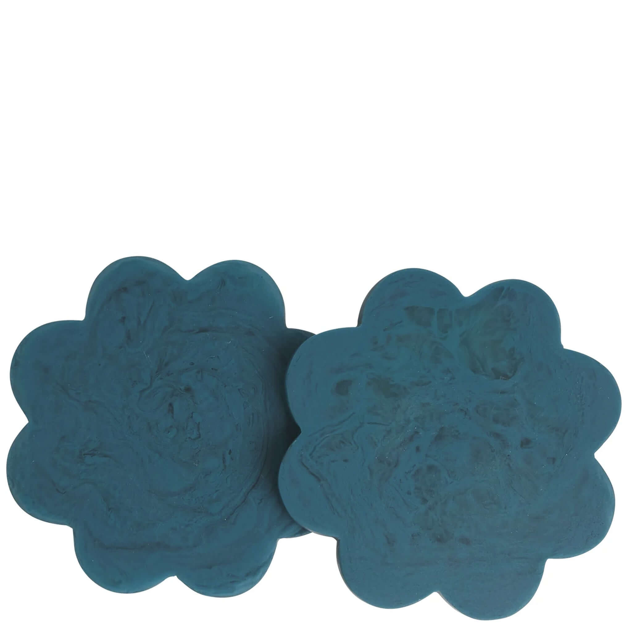 Teal resin coasters in a flower shape on a white background.