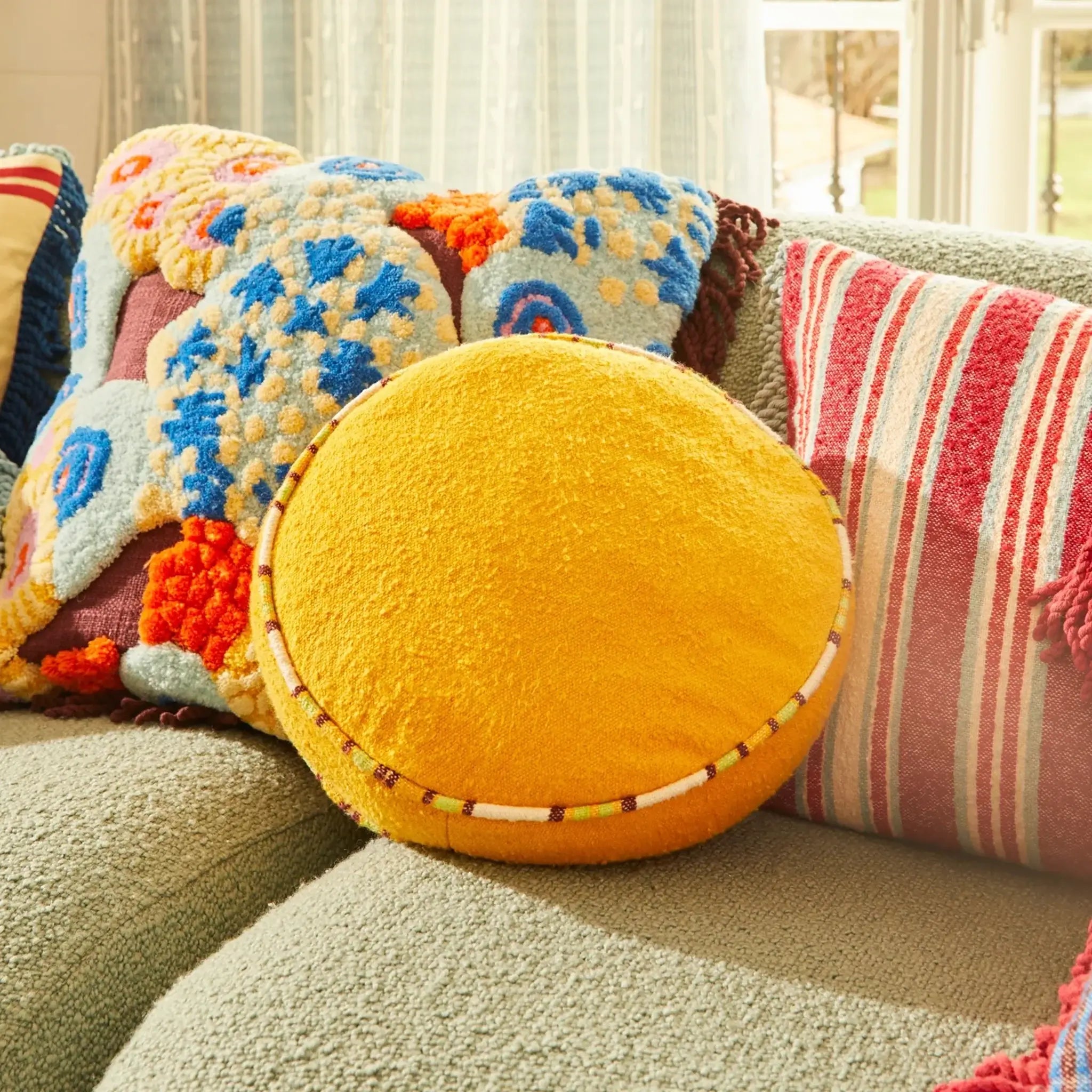 Colorful round and patterned cushions on a sofa