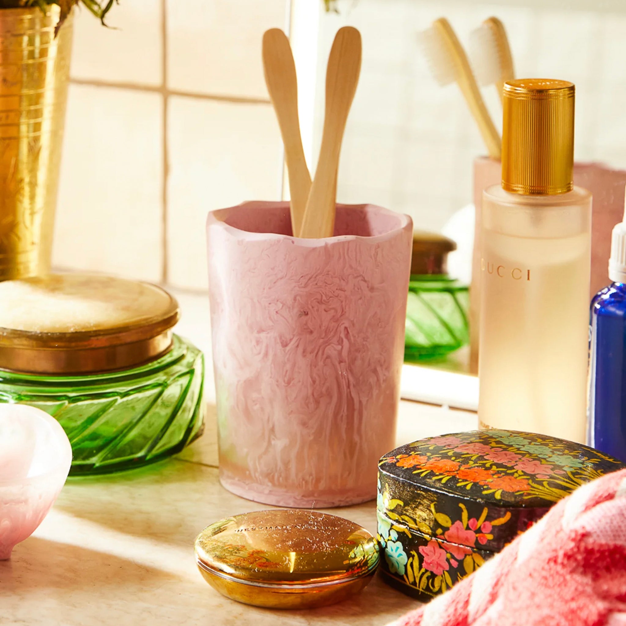 A pink resin drinking vessel with an irregular, organic shape.