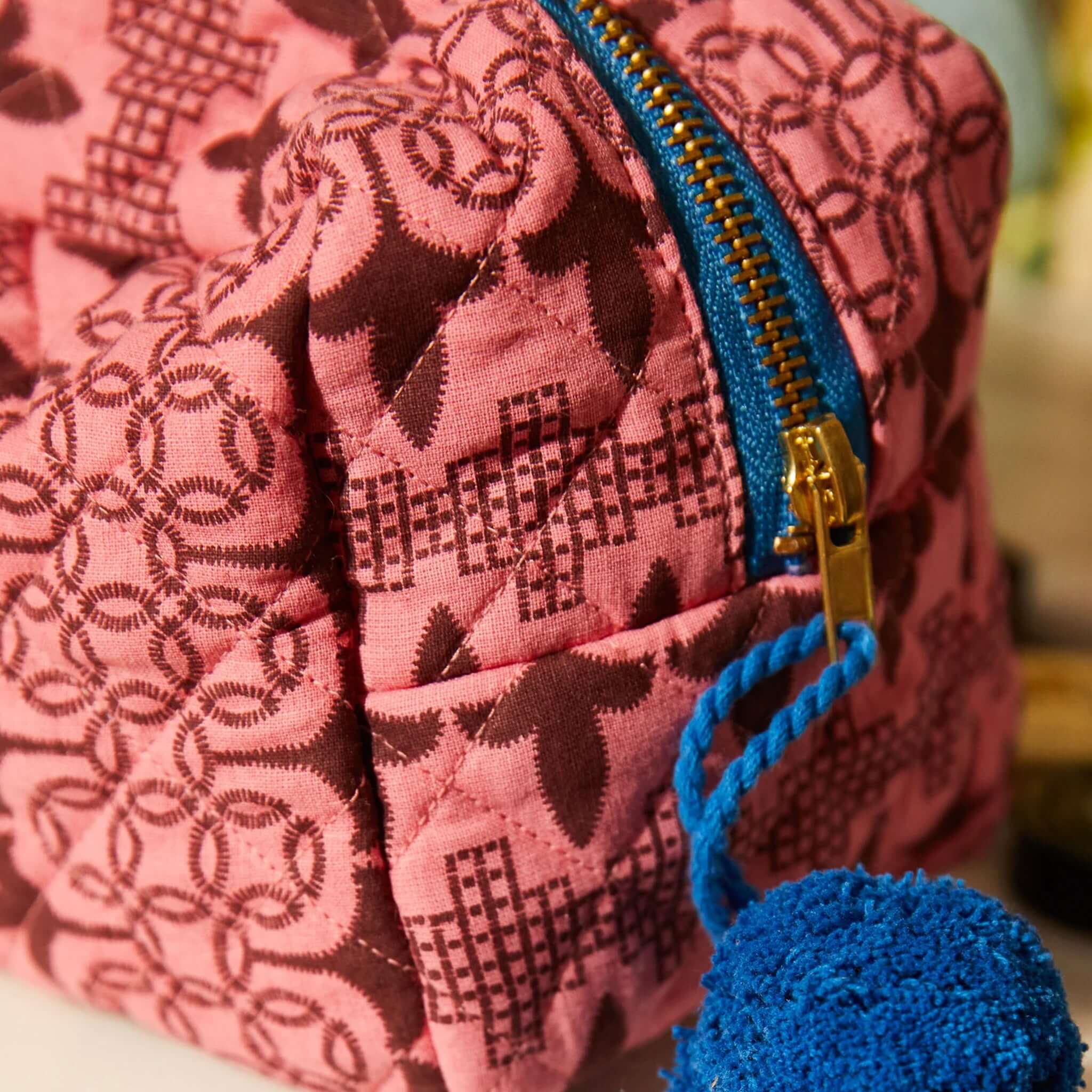 Alt Tag: Sage x Clare Esme Organic Cotton Beauty Bag pink quilted patterned pouch with blue zipper and tassel