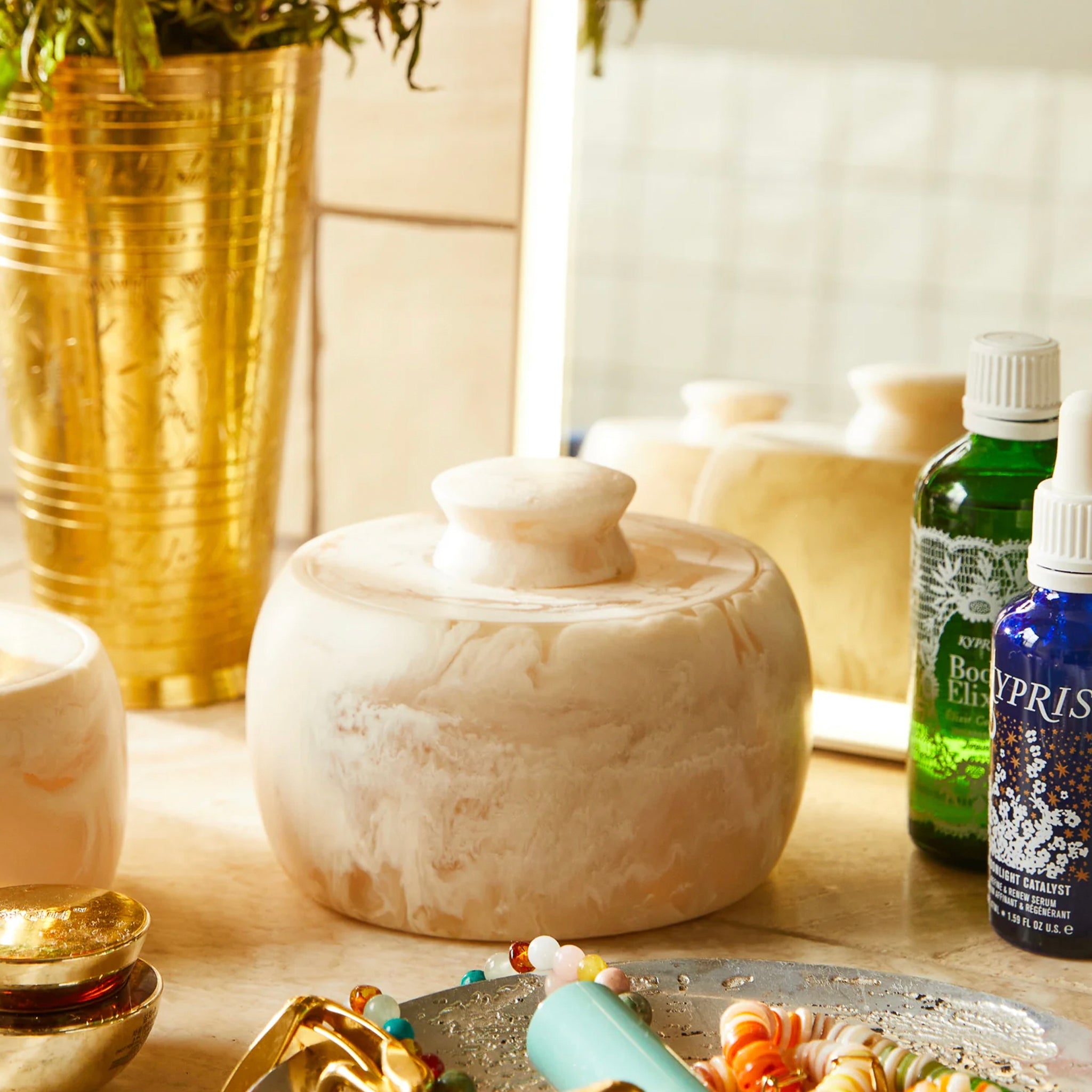 A beige and white marbled resin canister with a matching lid, hand-poured and swirled, with a minimalist design.