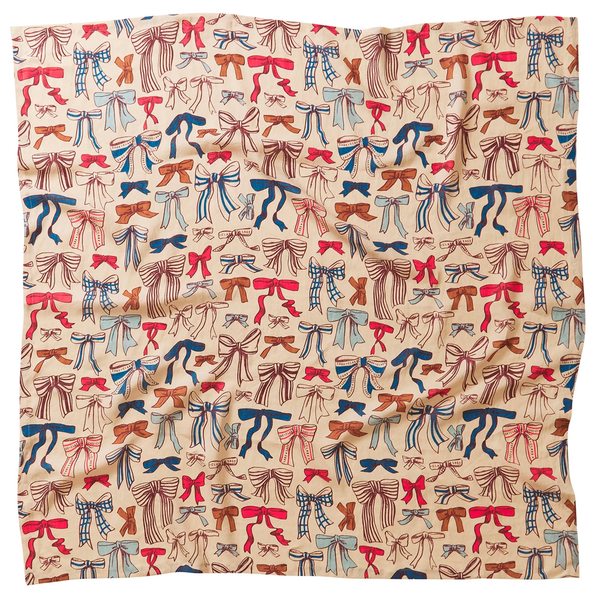 A linen tablecloth with a pattern of colorful bows in red, blue, and brown colors on a beige background.