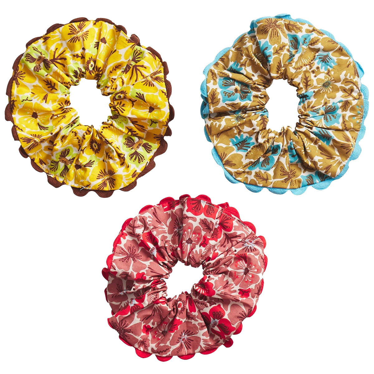 Sage x Clare Magnolia Hair Scrunchie Set, three floral scrunchies in yellow, cognac blue and pink with ric rac trim