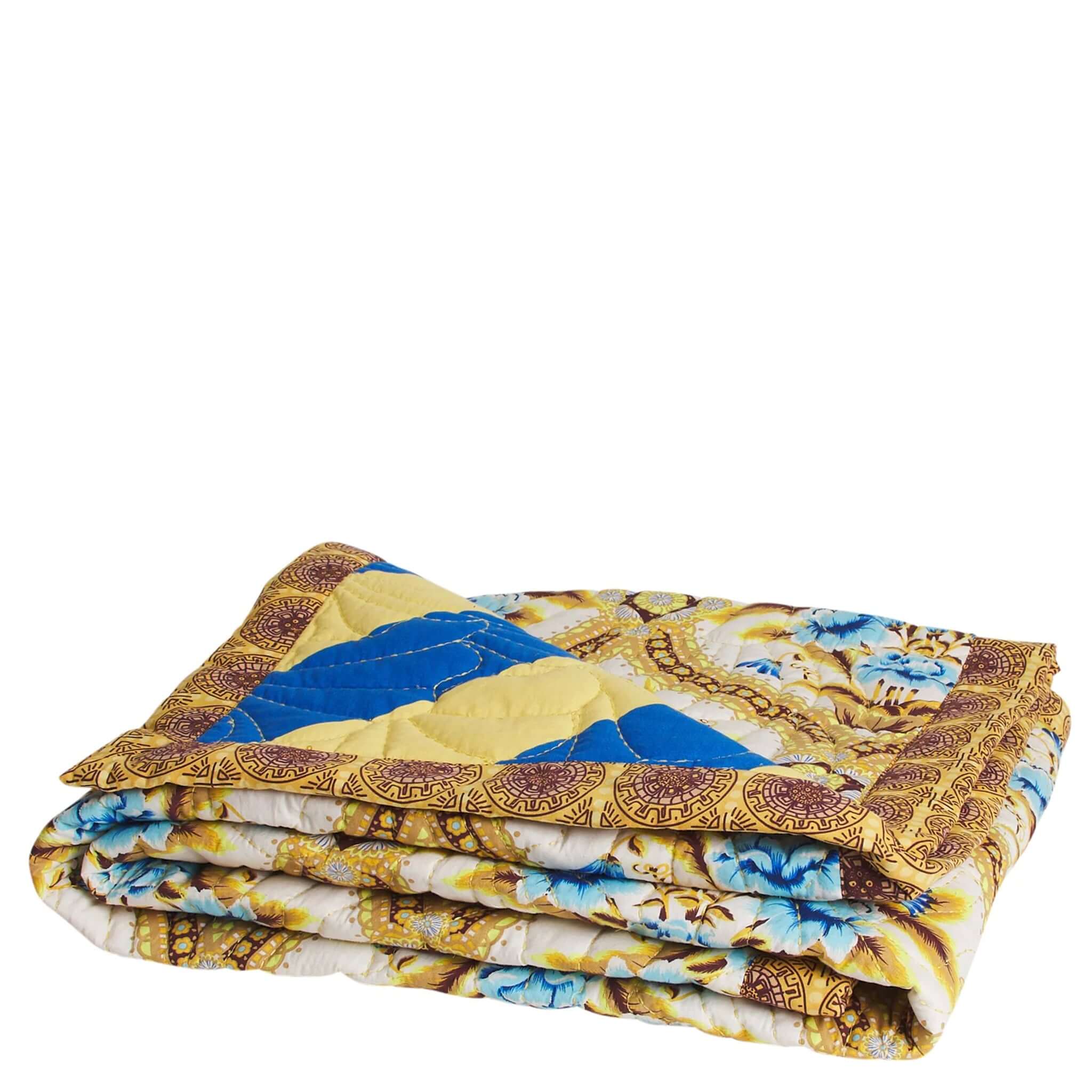 Folded quilt with a floral pattern on a white background