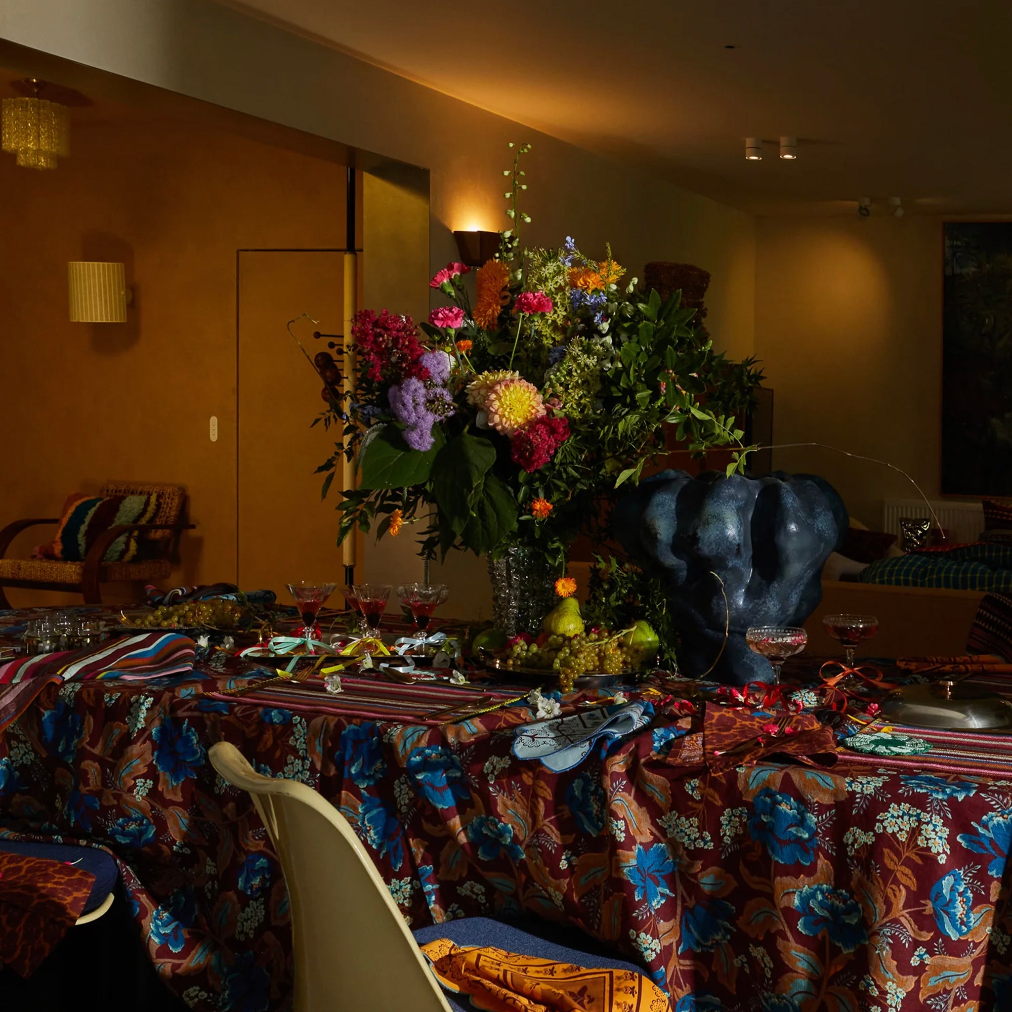 A mahogany colored linen tablecloth with a floral pattern on a table.