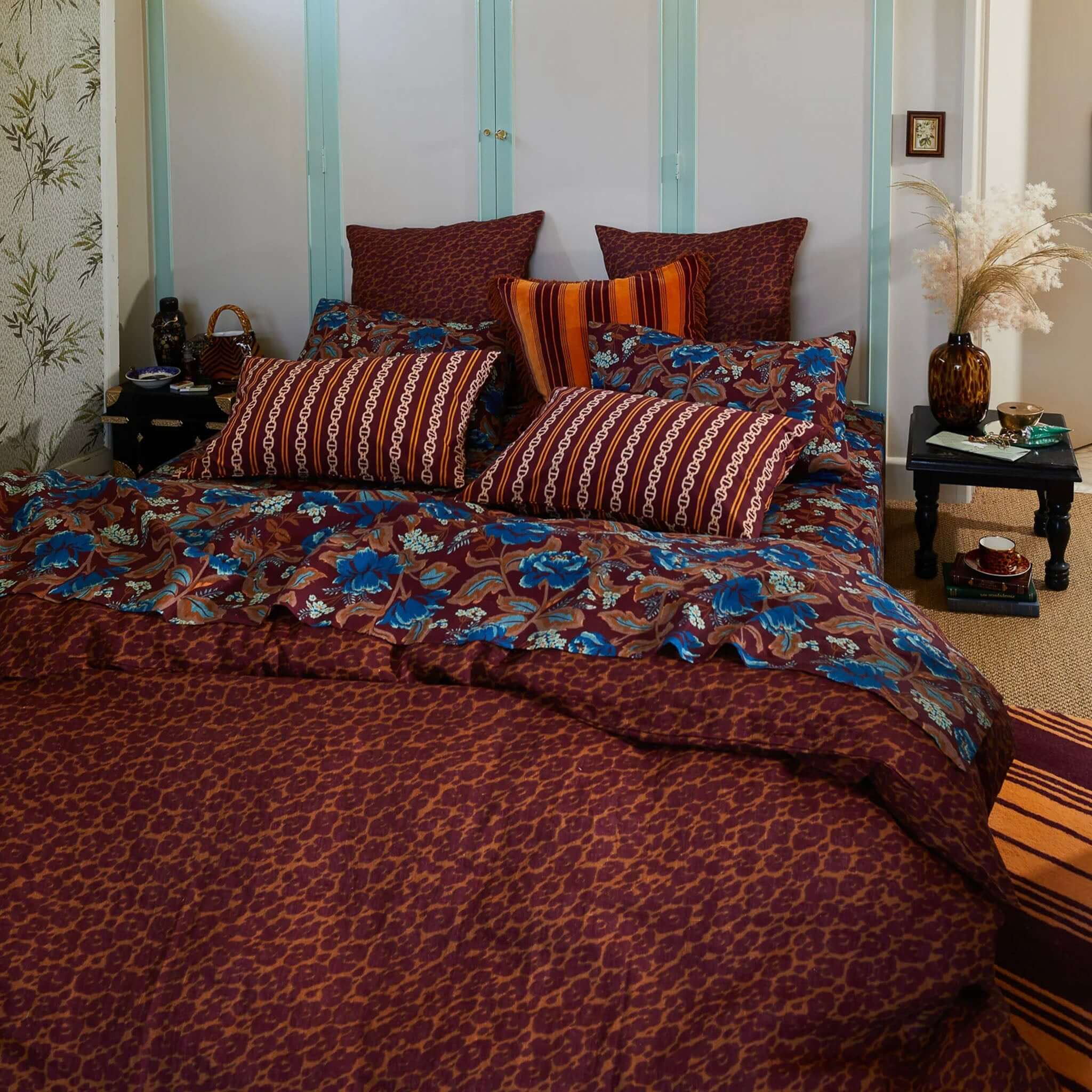 A linen duvet cover with a leopard-like print in a mix of brown and red colors on a bed.