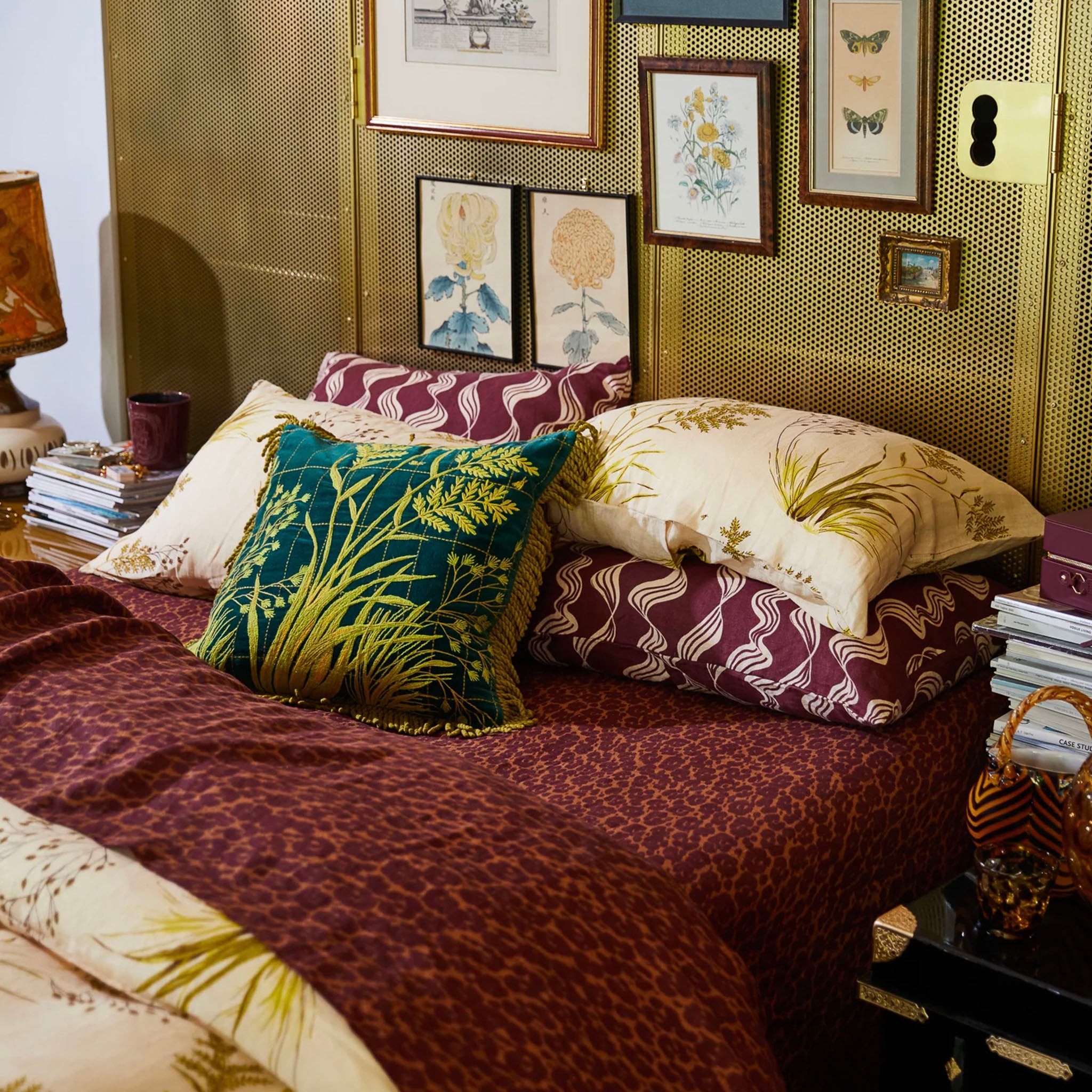 A folded brown and beige patterned linen fitted sheet on a bed.
