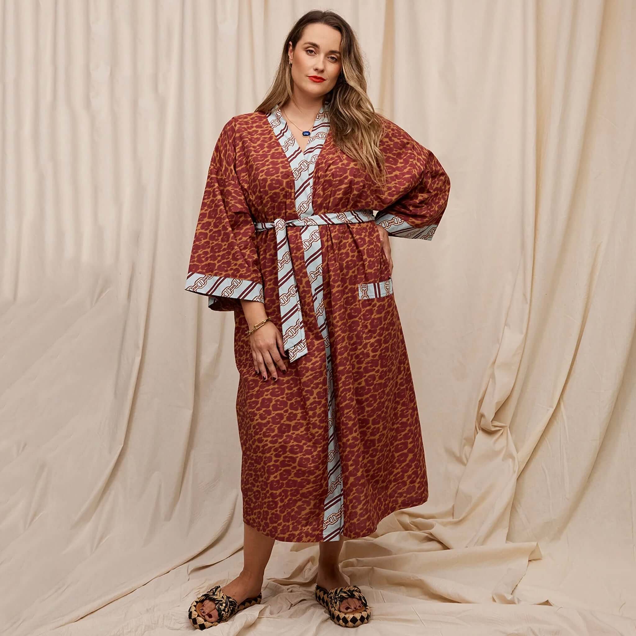 A woman wearing a brown leopard dressing gown.