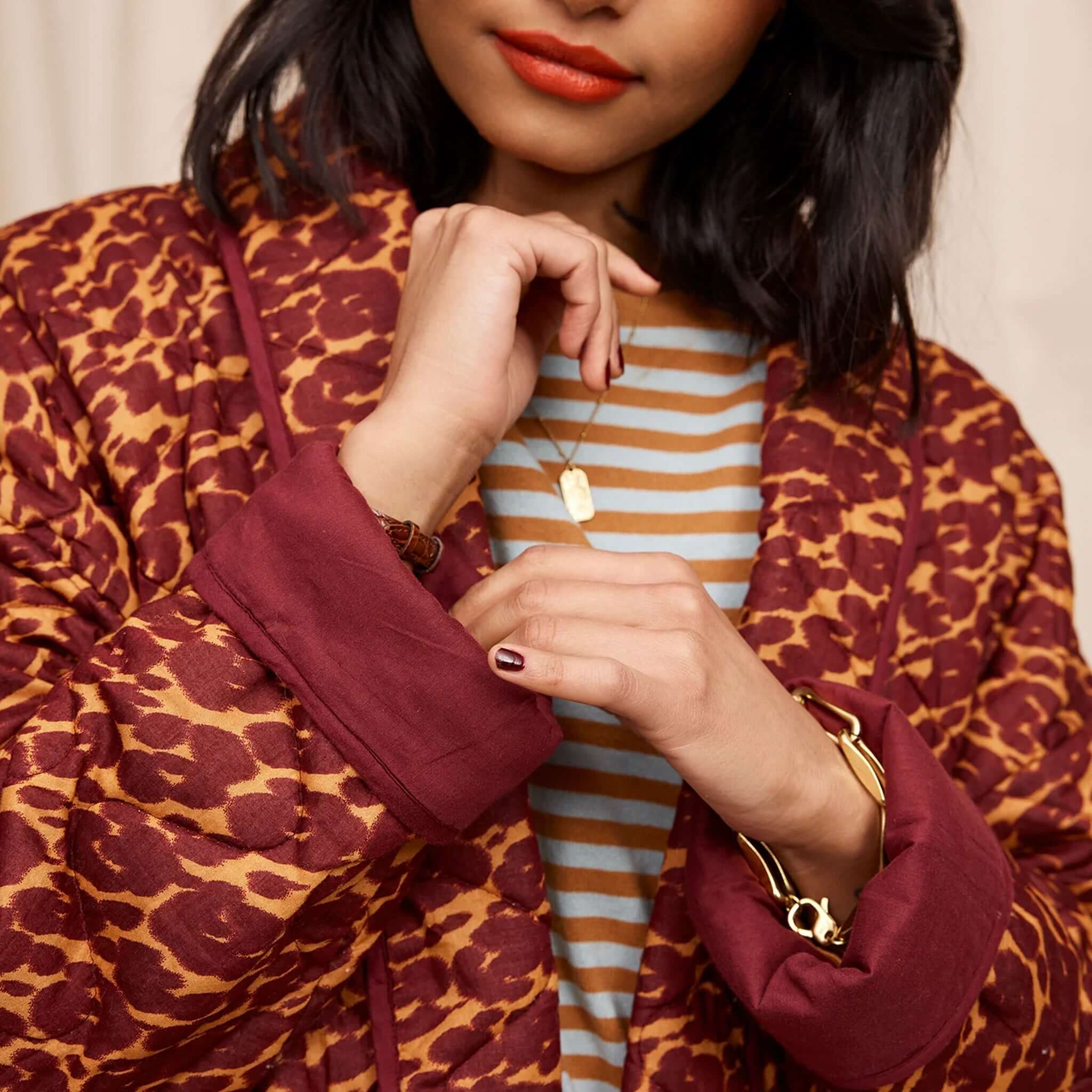 Woman wearing a brown padded quilted jacket.
