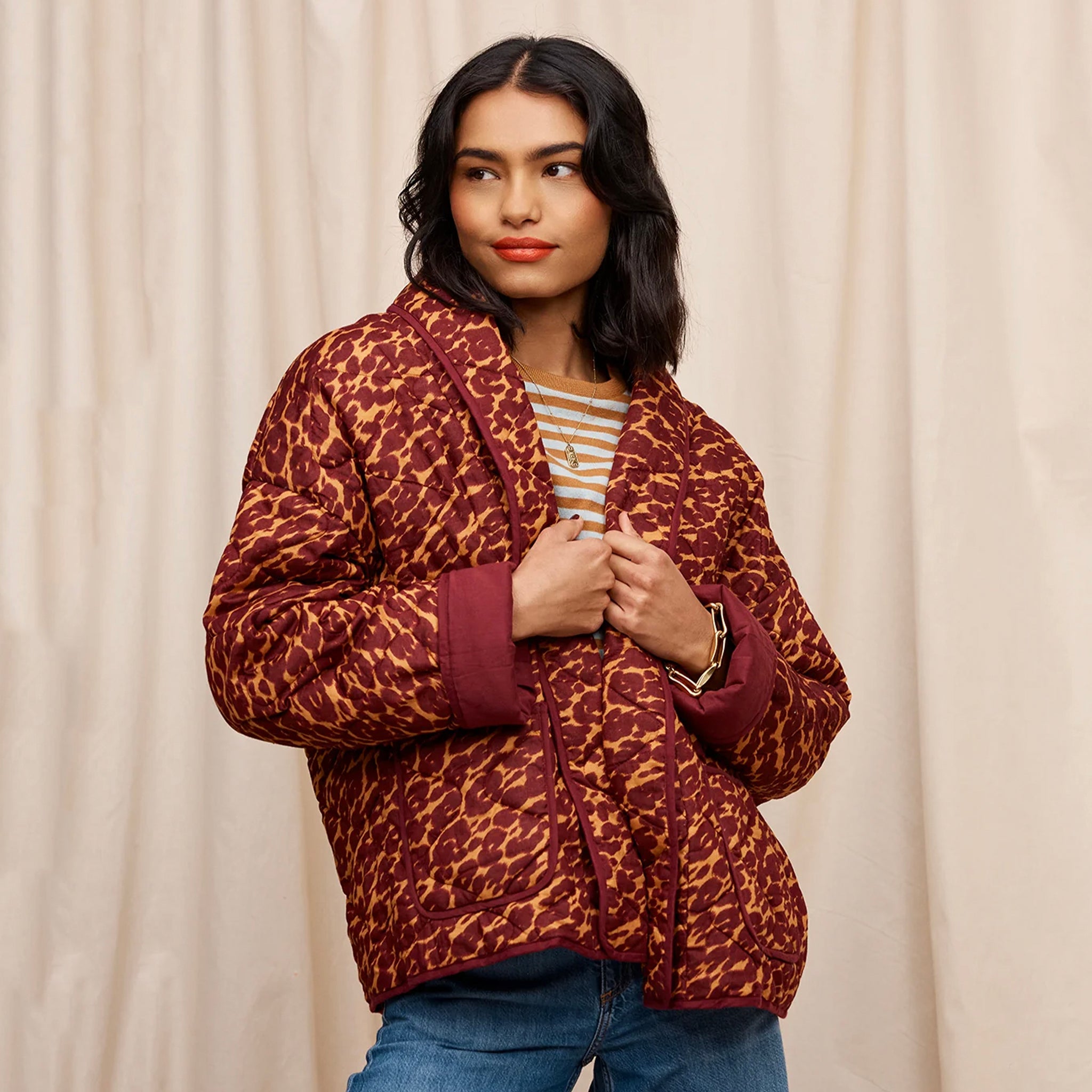 Woman wearing a brown padded quilted jacket.