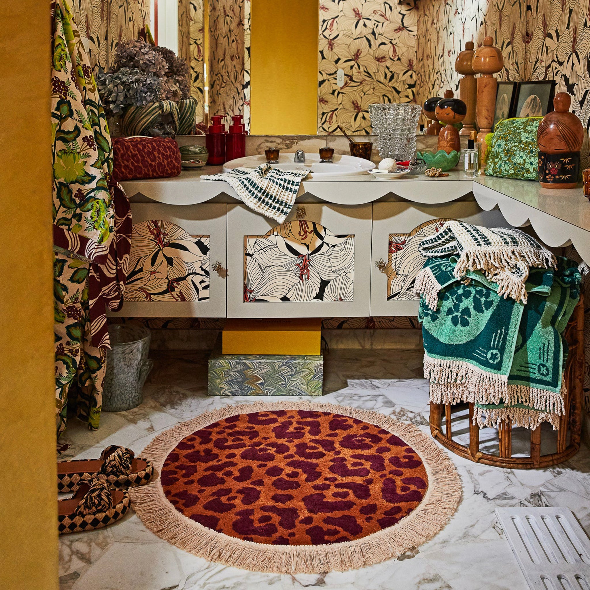 Decorative interior with a leopard print rug, patterned furniture, and colorful decor items.