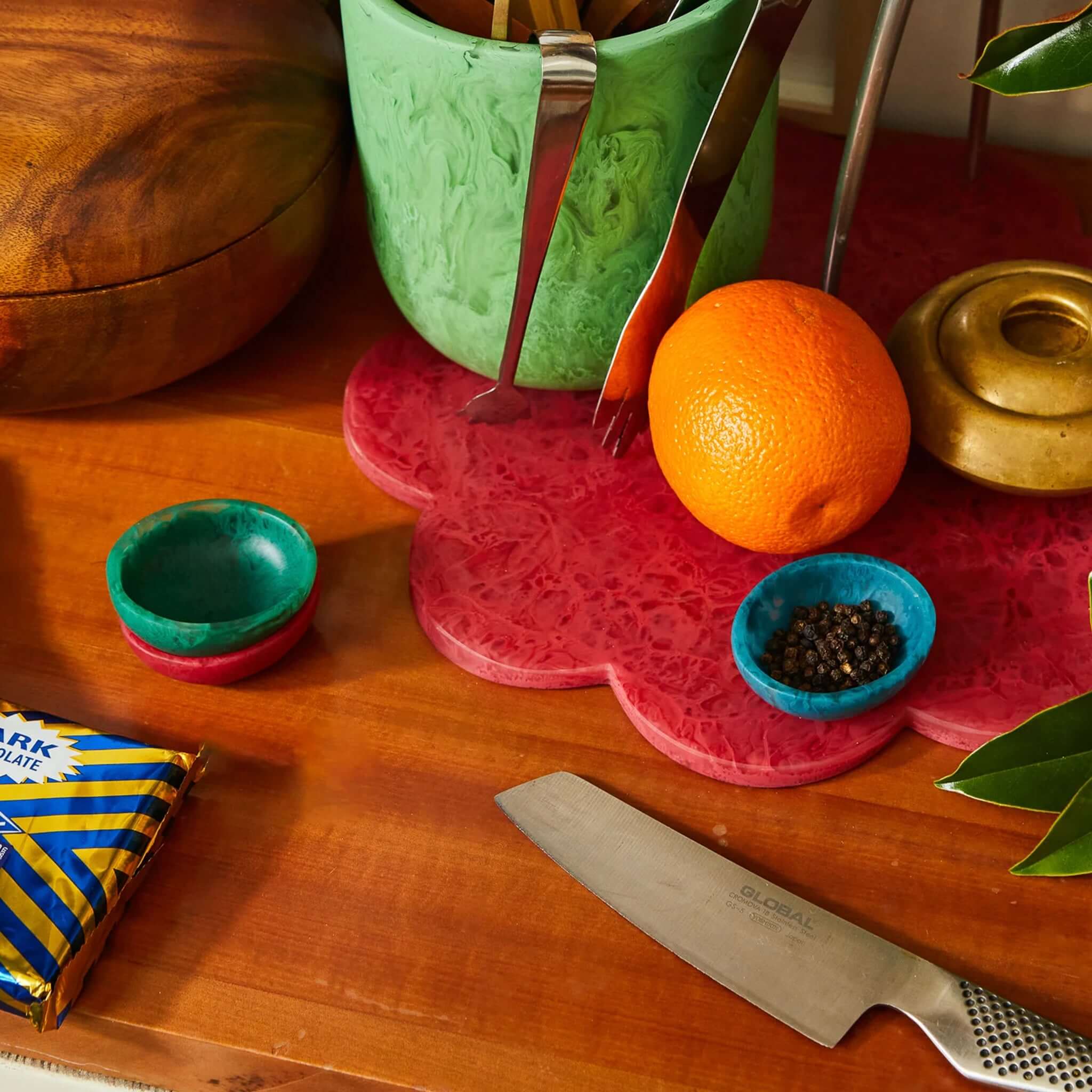 A small green resin bowl on a white background, part of the Astrid collection.