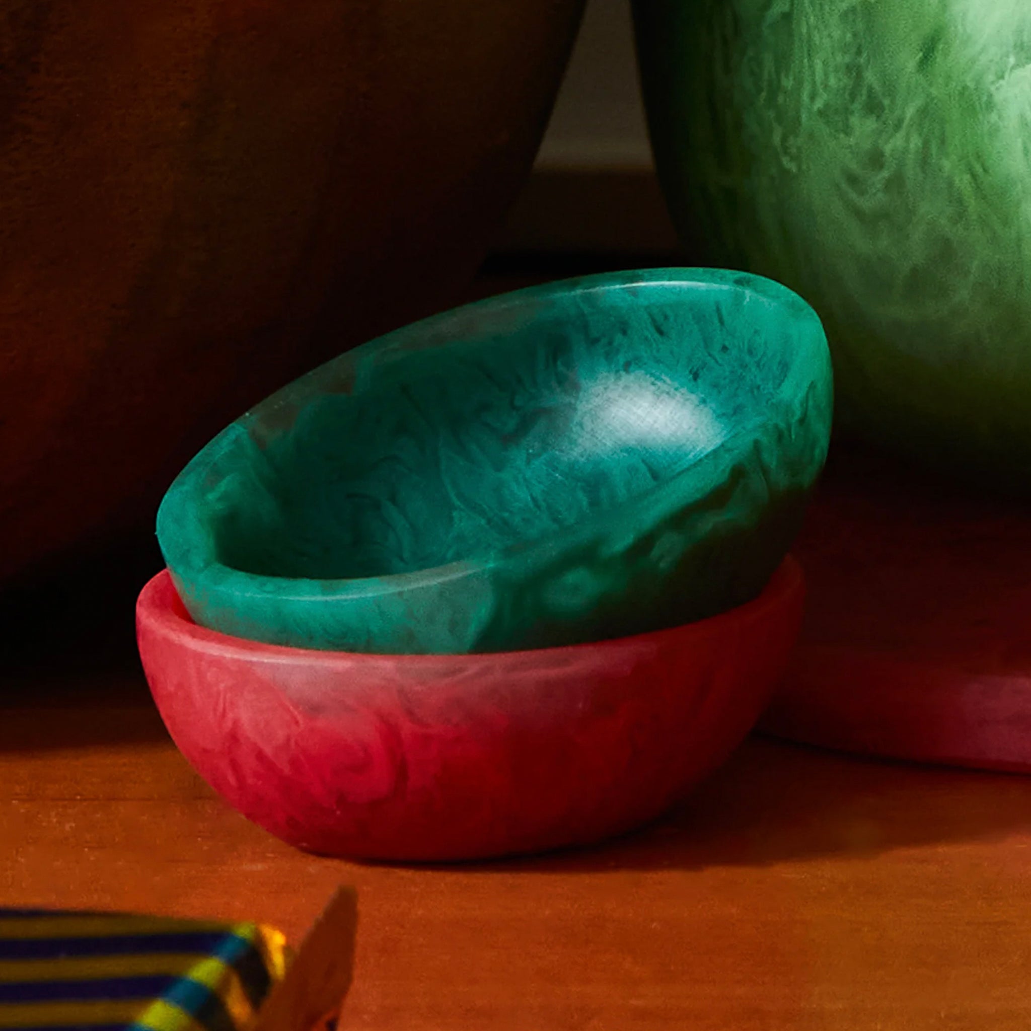 A small green resin bowl on a white background, part of the Astrid collection.
