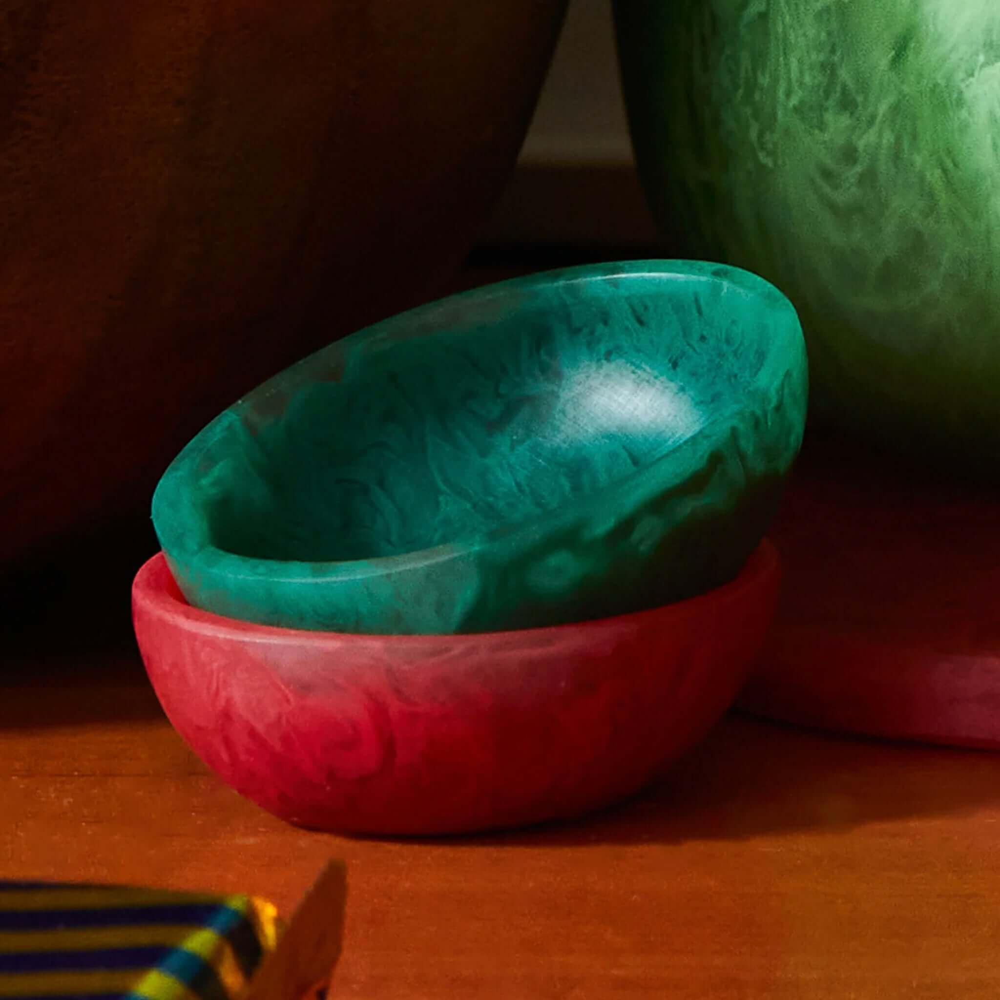 A small green resin bowl on a white background, part of the Astrid collection.