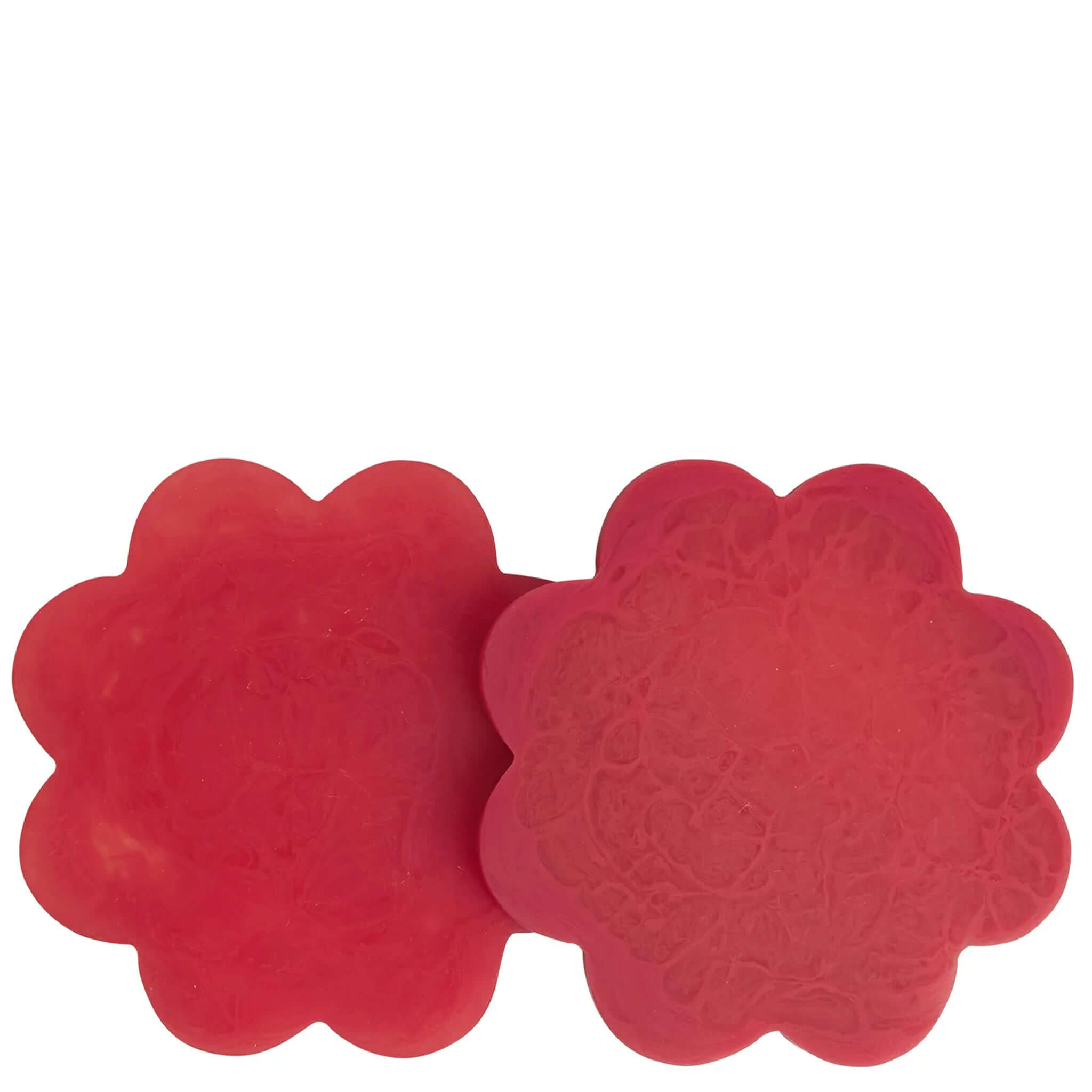 A set of two red floral resin coasters with scalloped edges.