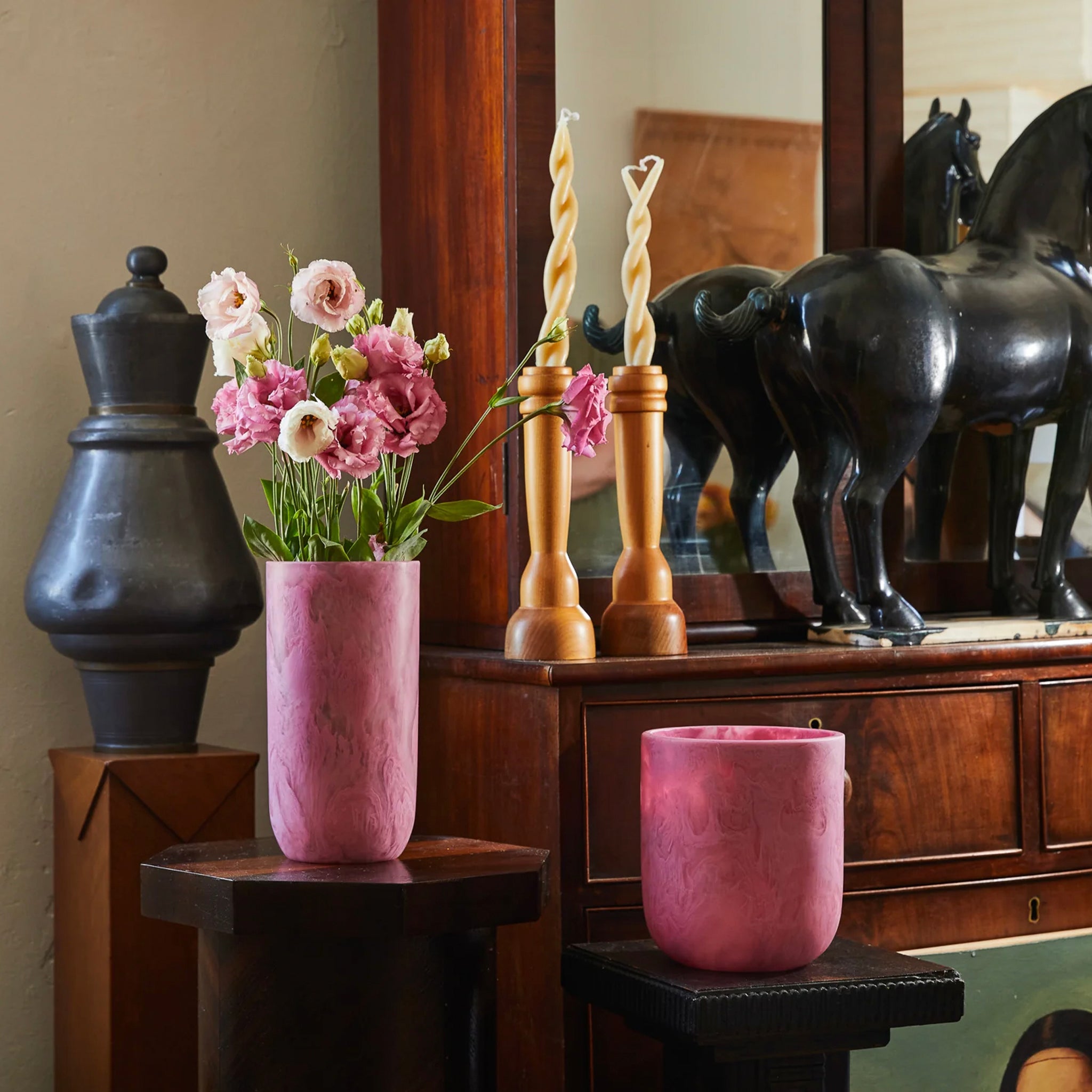 A pink cylindrical vase, the Sage x Clare Kalinda Vase, with a textured surface.