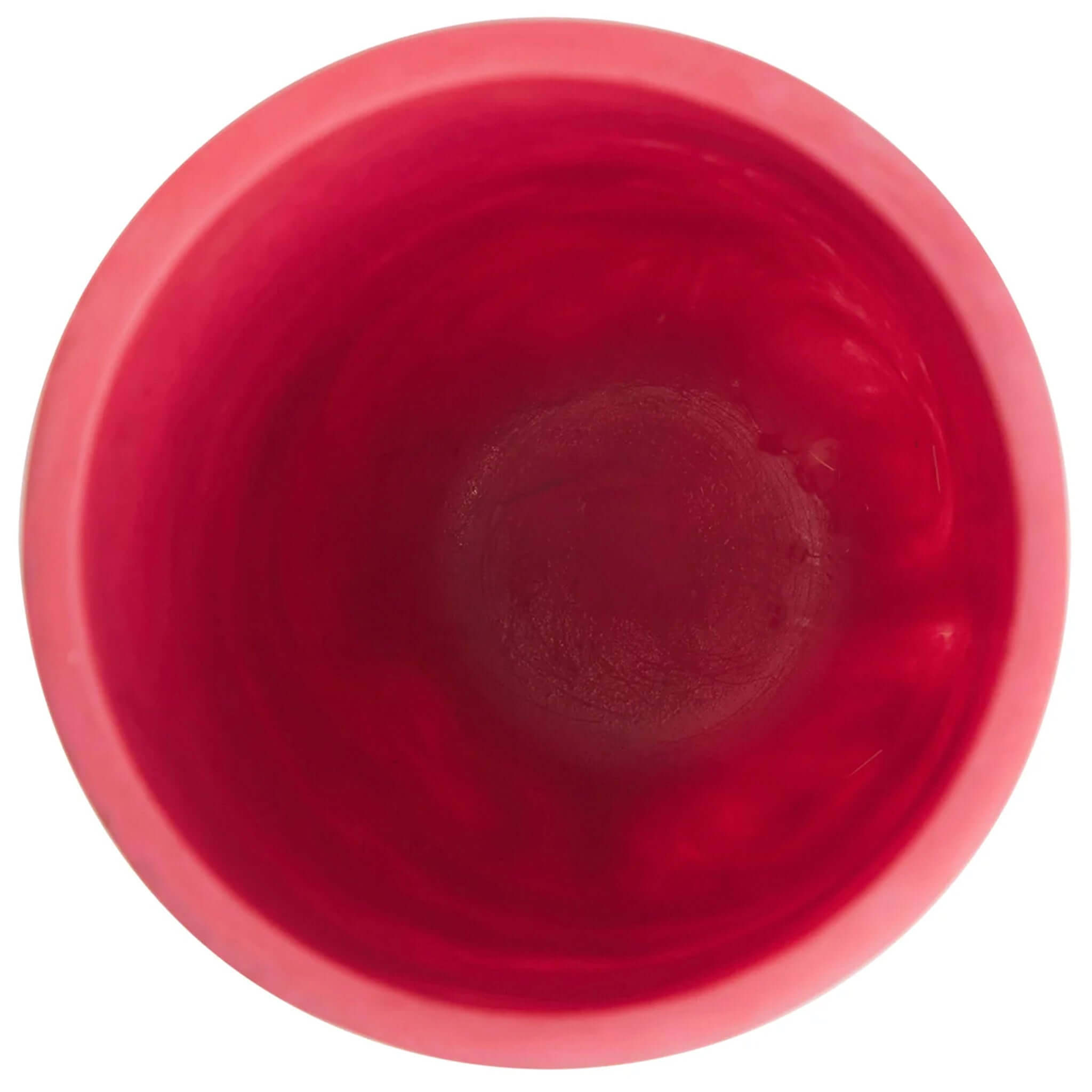 A red cylindrical vase, the Sage x Clare Kalinda Vase, with a textured surface.