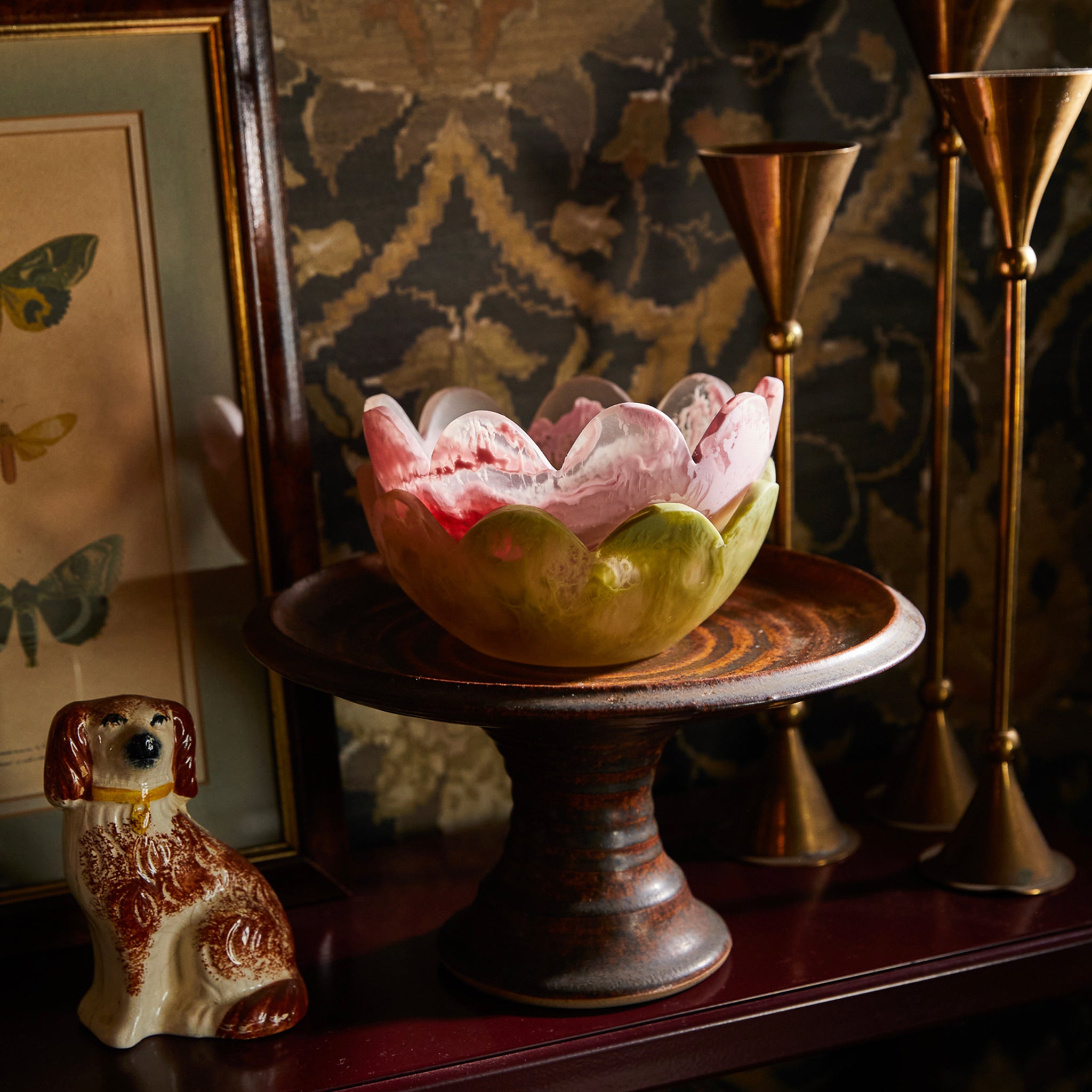 A pink resin petal-shaped bowl with scalloped edges.