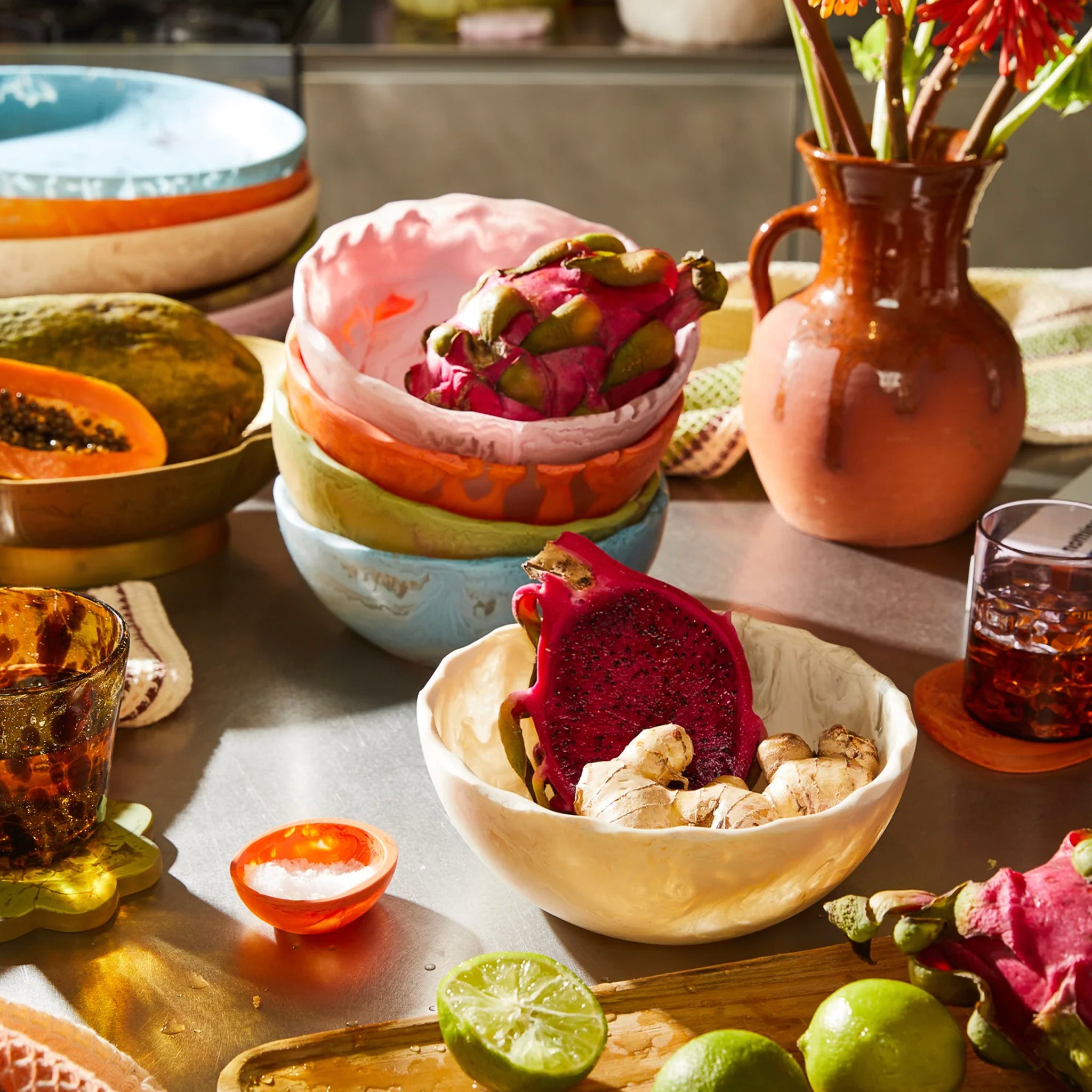 A white resin bowl with a smooth finish, wide at the top and narrow at the bottom, on a plain background.