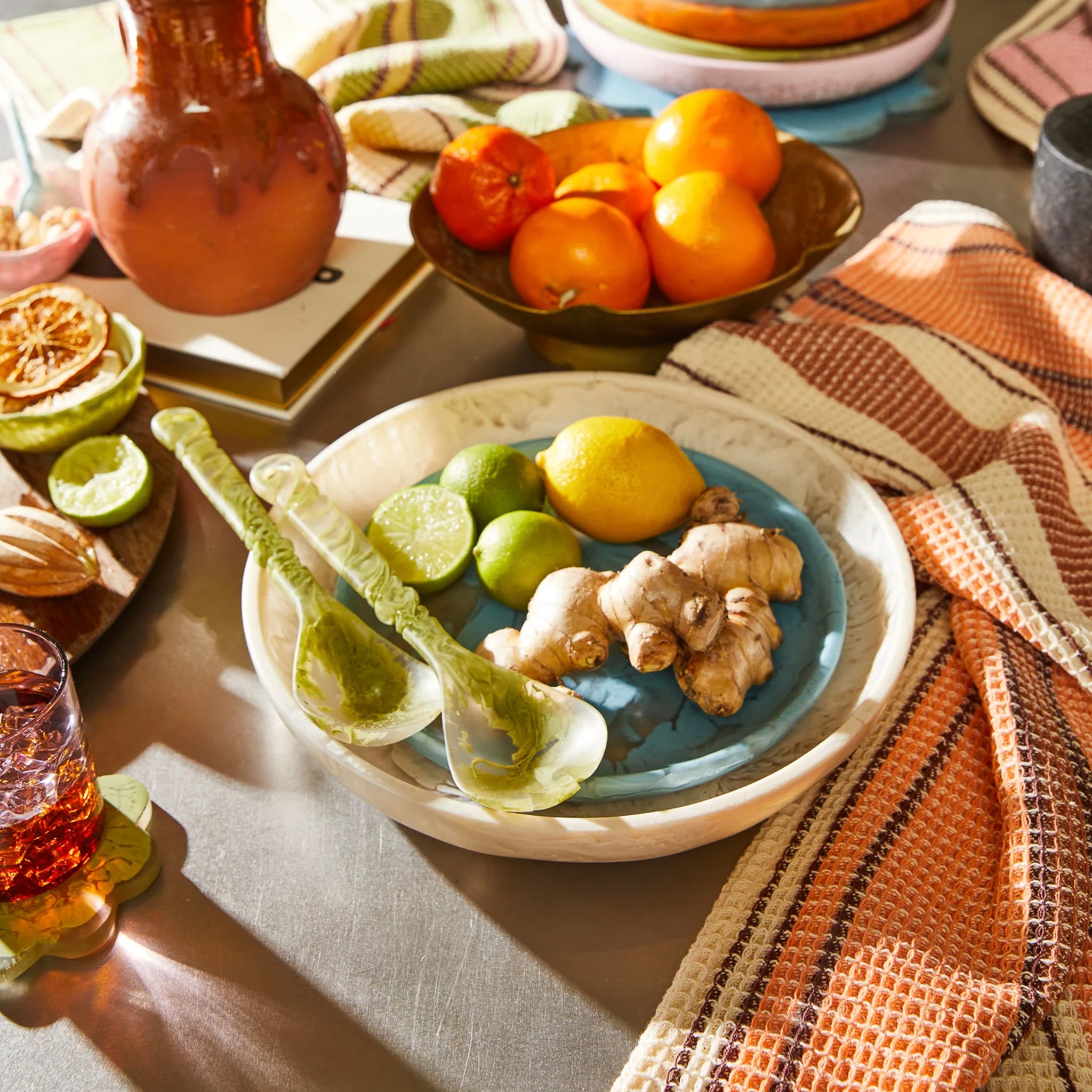 A beige, round, resin serving platter with a smooth surface on a table.