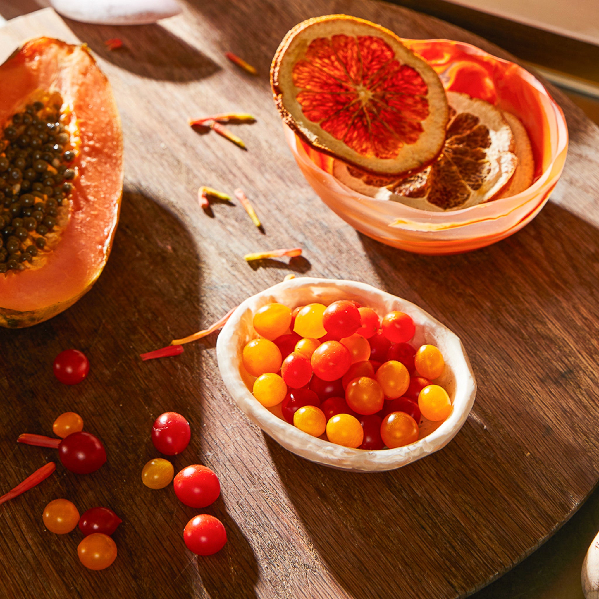 A small, beige-colored, resin mini bowl with a marbled pattern. on a table.