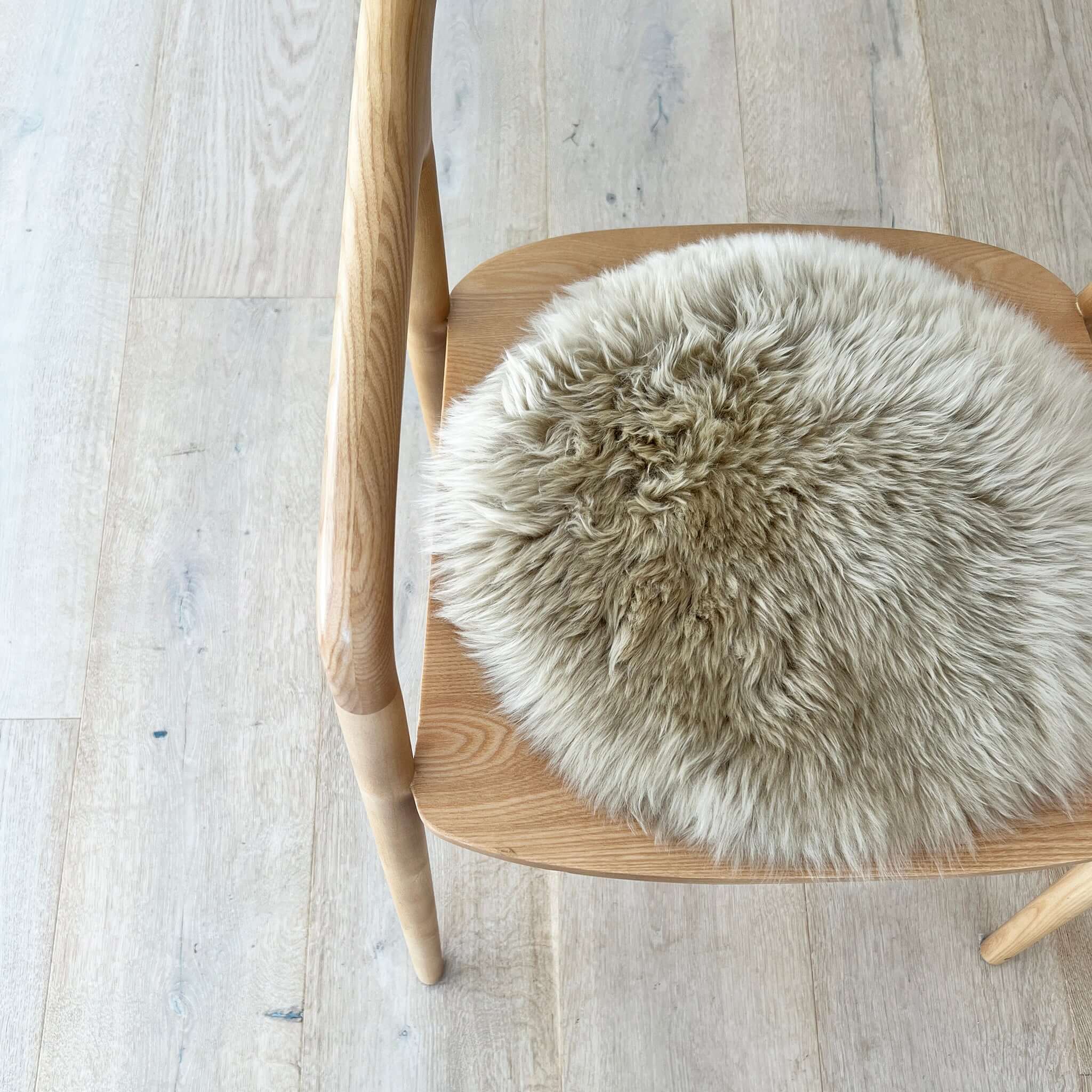 Alt Tag: Long Wool Sheepskin Circle Chair Pad - Nappa on wooden chair, round long wool sheepskin seat pad for comfort