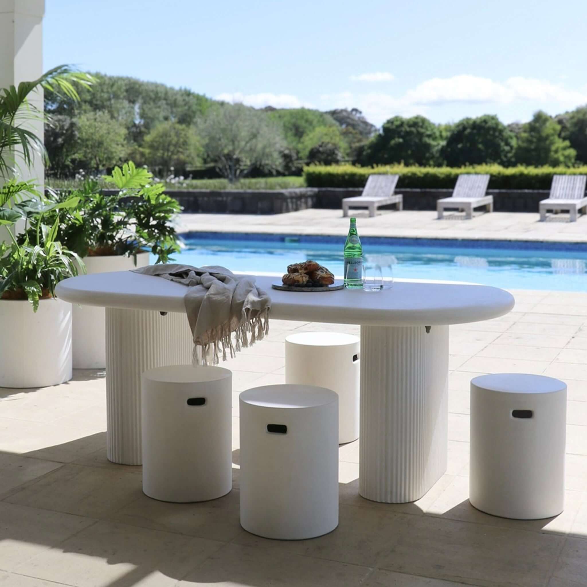 Concrete Side Table / Stool - Round minimalist concrete stools and side tables around outdoor pool patio setting