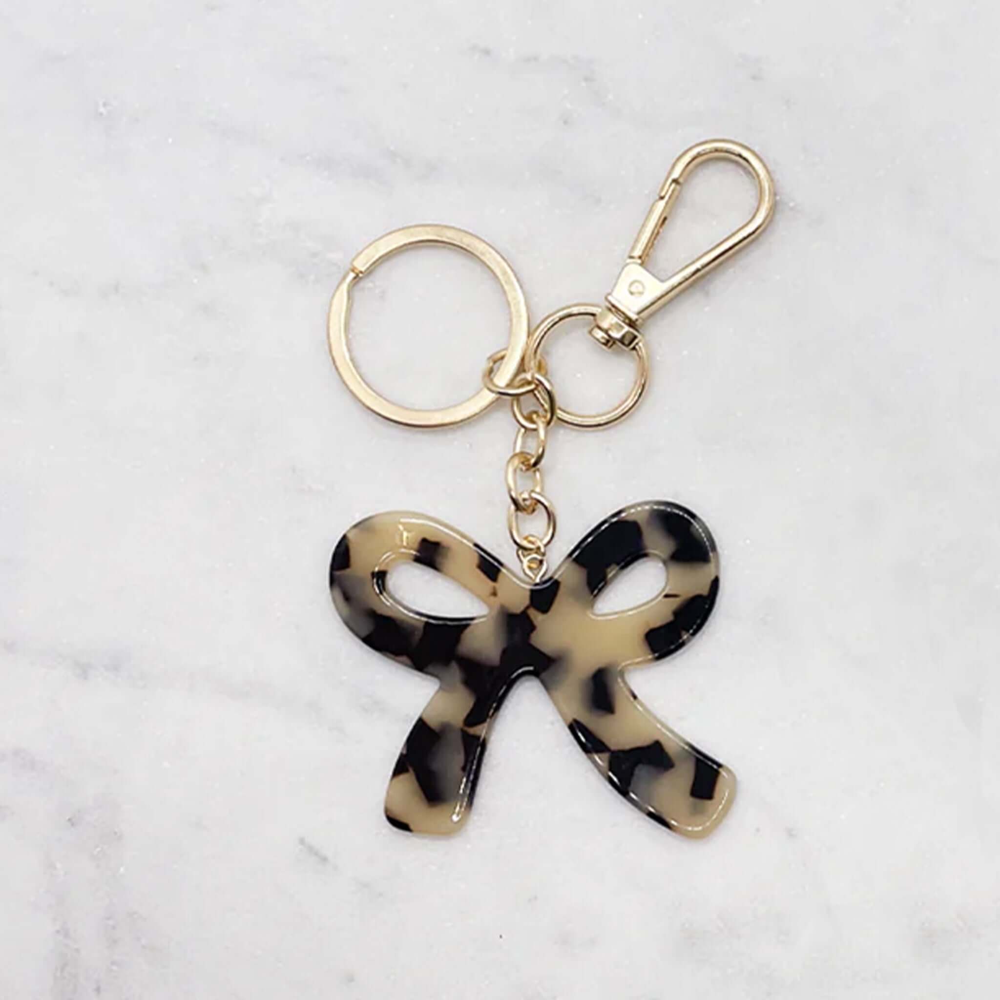 Alt Tag: Sophie Bow Beauty Keychain - Light Tort acetate tortoiseshell bow keychain with gold-coloured hardware and clasp