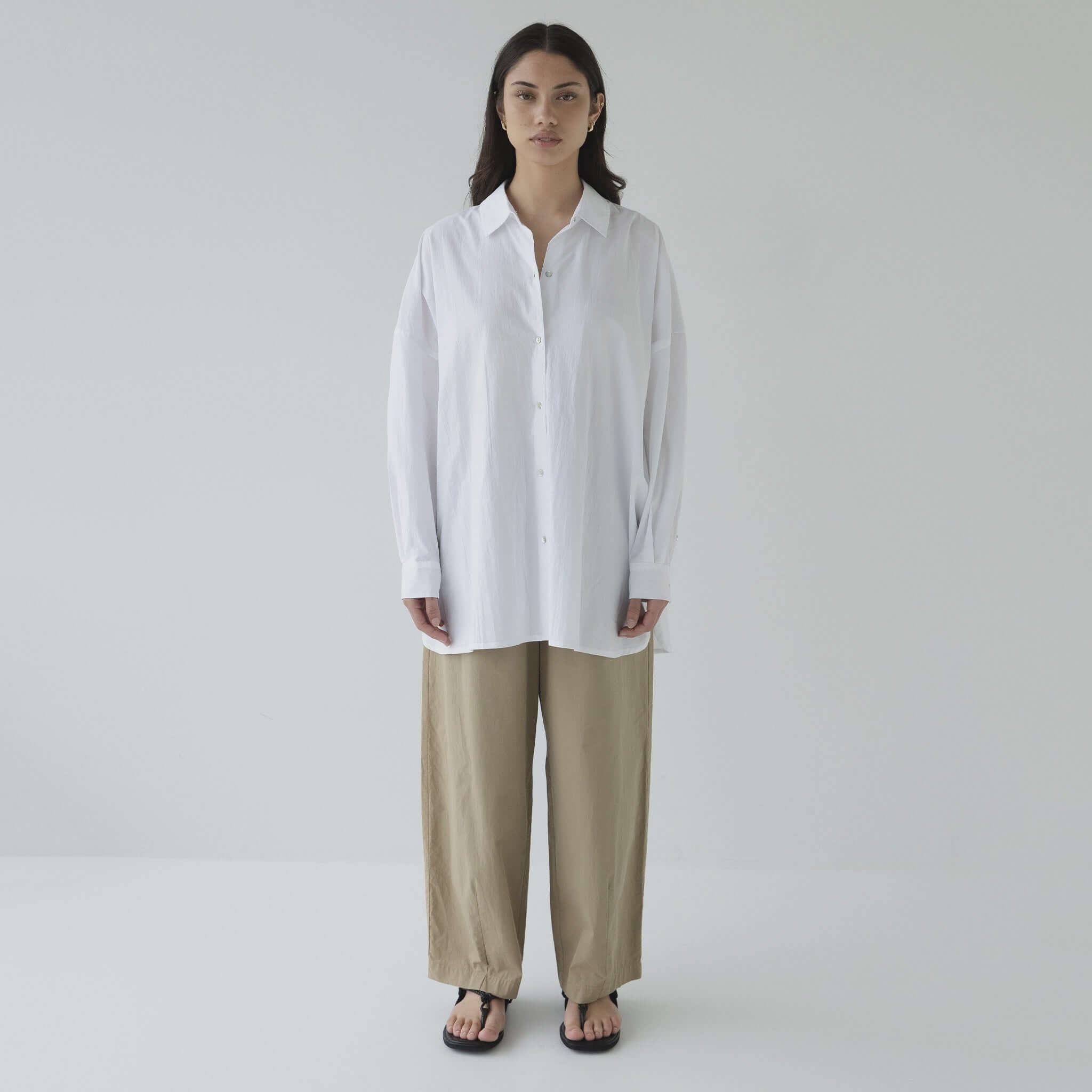 Alt Tag: Sophie Effortless Pants - Sand lightweight cotton barrel-leg pants with elastic waist, styled with oversized white shirt
