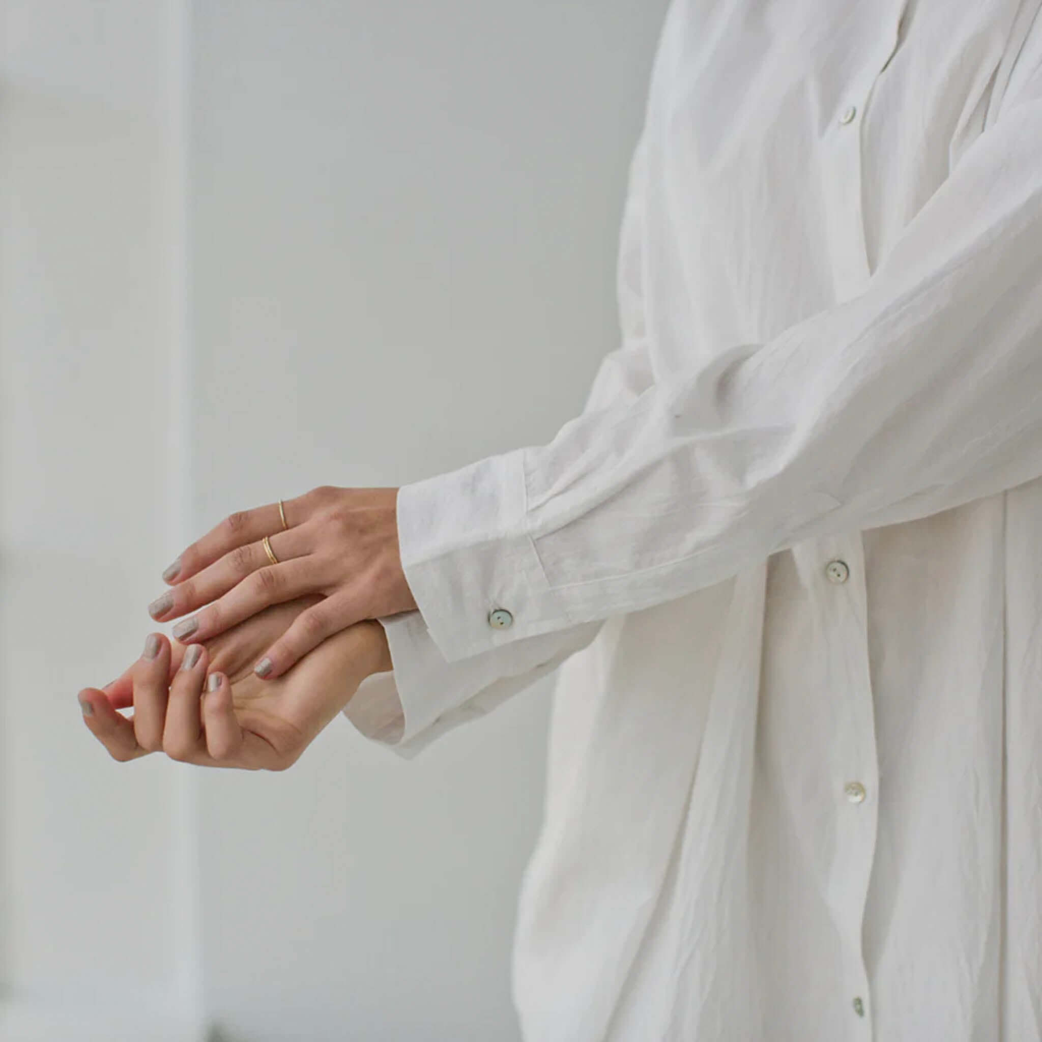 Alt Tag: Sophie Always Shirt - White oversized cotton shirt with shell buttons, curved hem and box pleat, worn with sleeves rolled