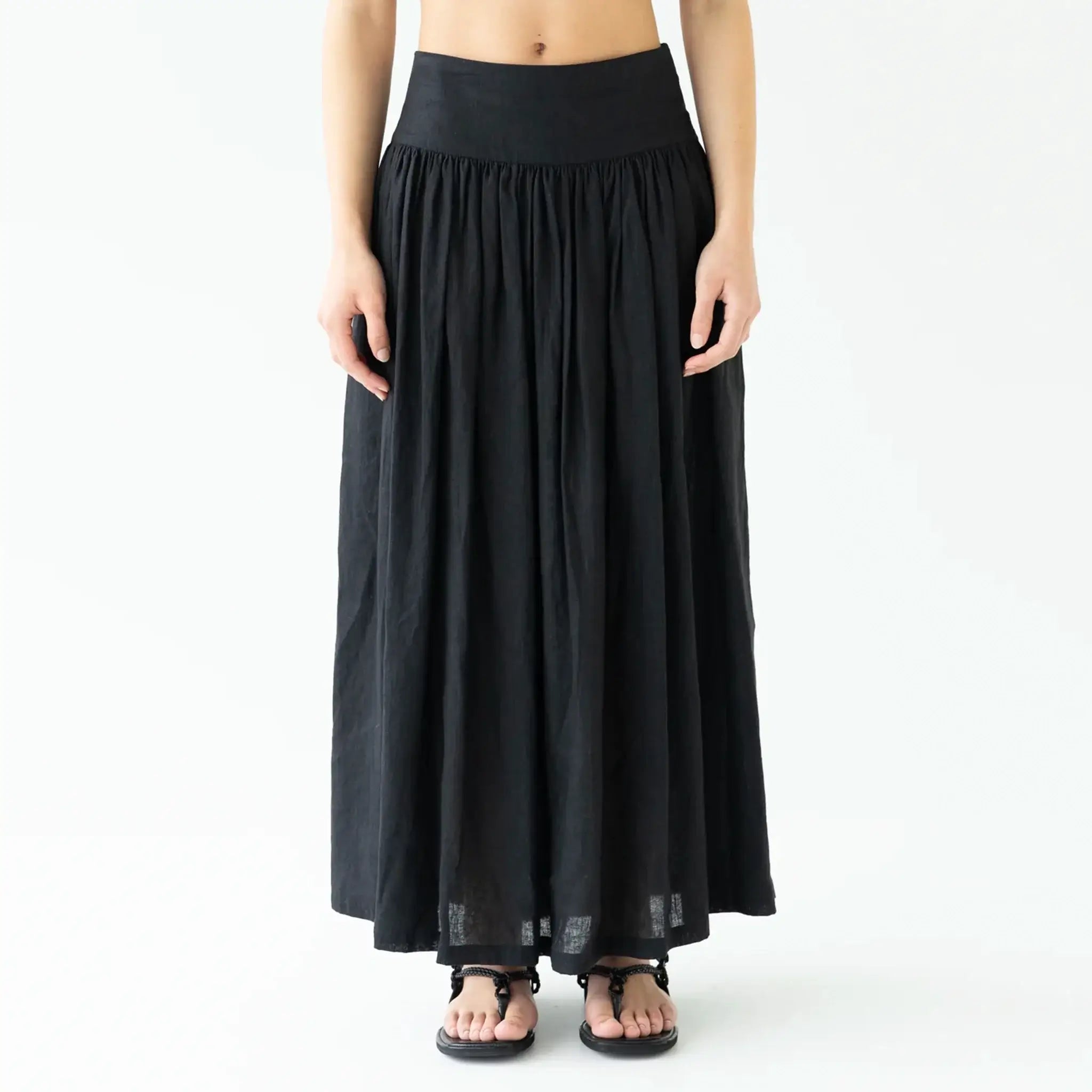 Person wearing a black long skirt on a white background