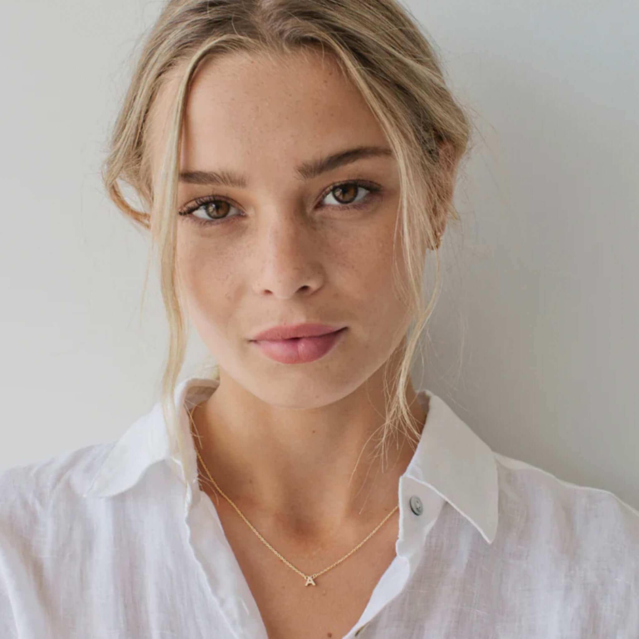 Alt Tag: Sophie Little Letter Necklace - Sterling Silver initial pendant on delicate chain worn by model, everyday minimal jewelry