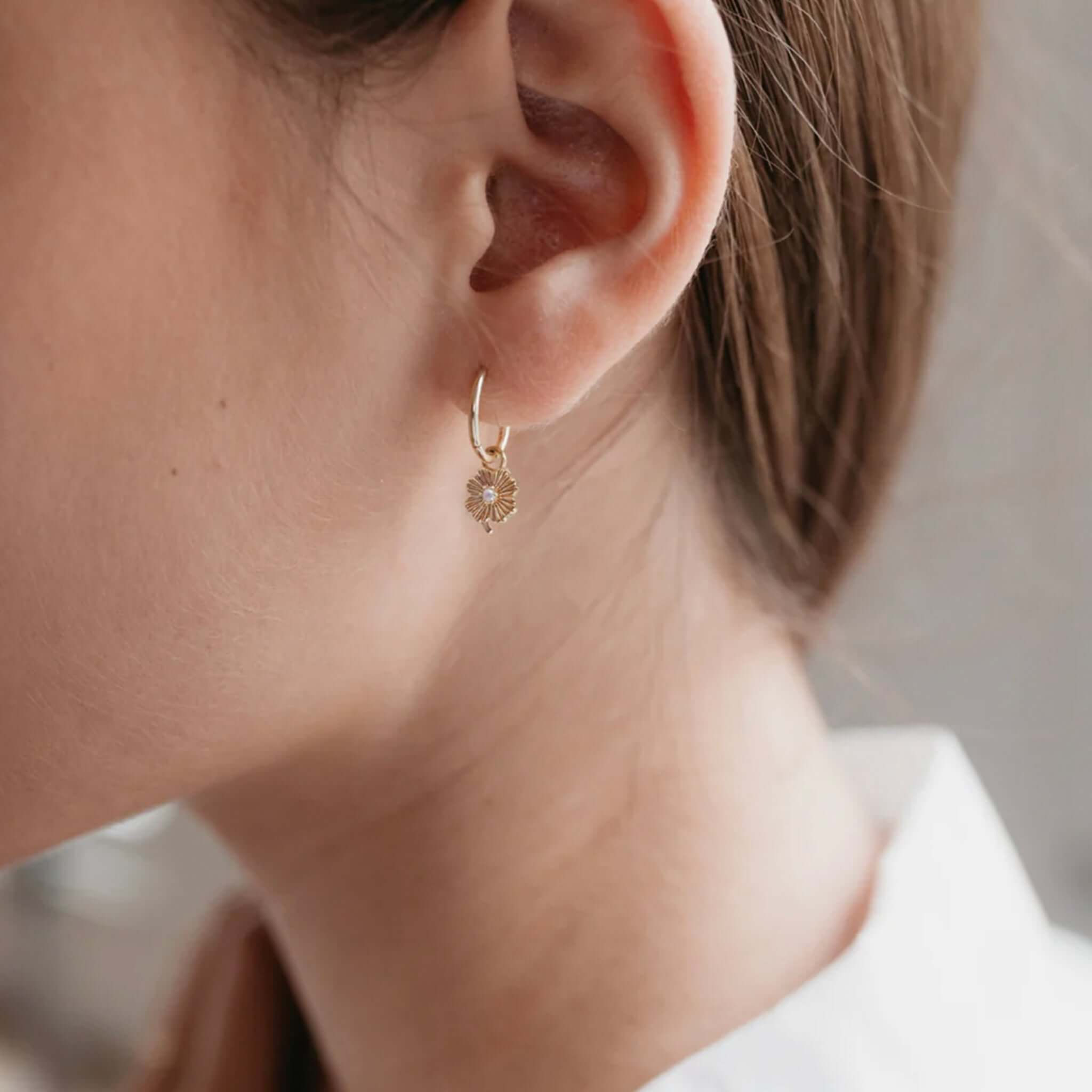 Alt Tag: Sophie Love Lily Sleeper Earrings gold plated sleeper hoop with lily pendant and pearl on ear