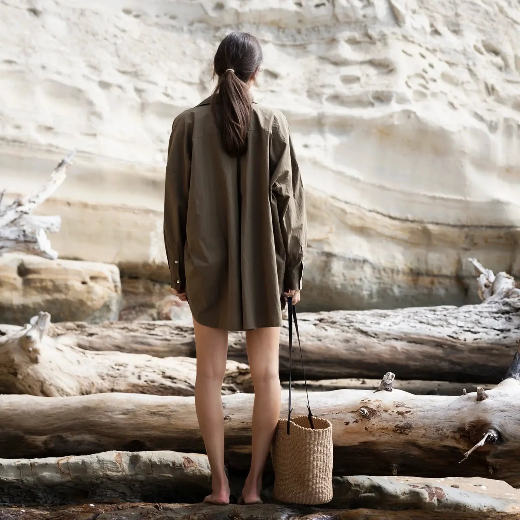 Sophie Love this Shirt - Forest oversized cotton shirt with curved hem and shell buttons, worn outdoors by model from behind