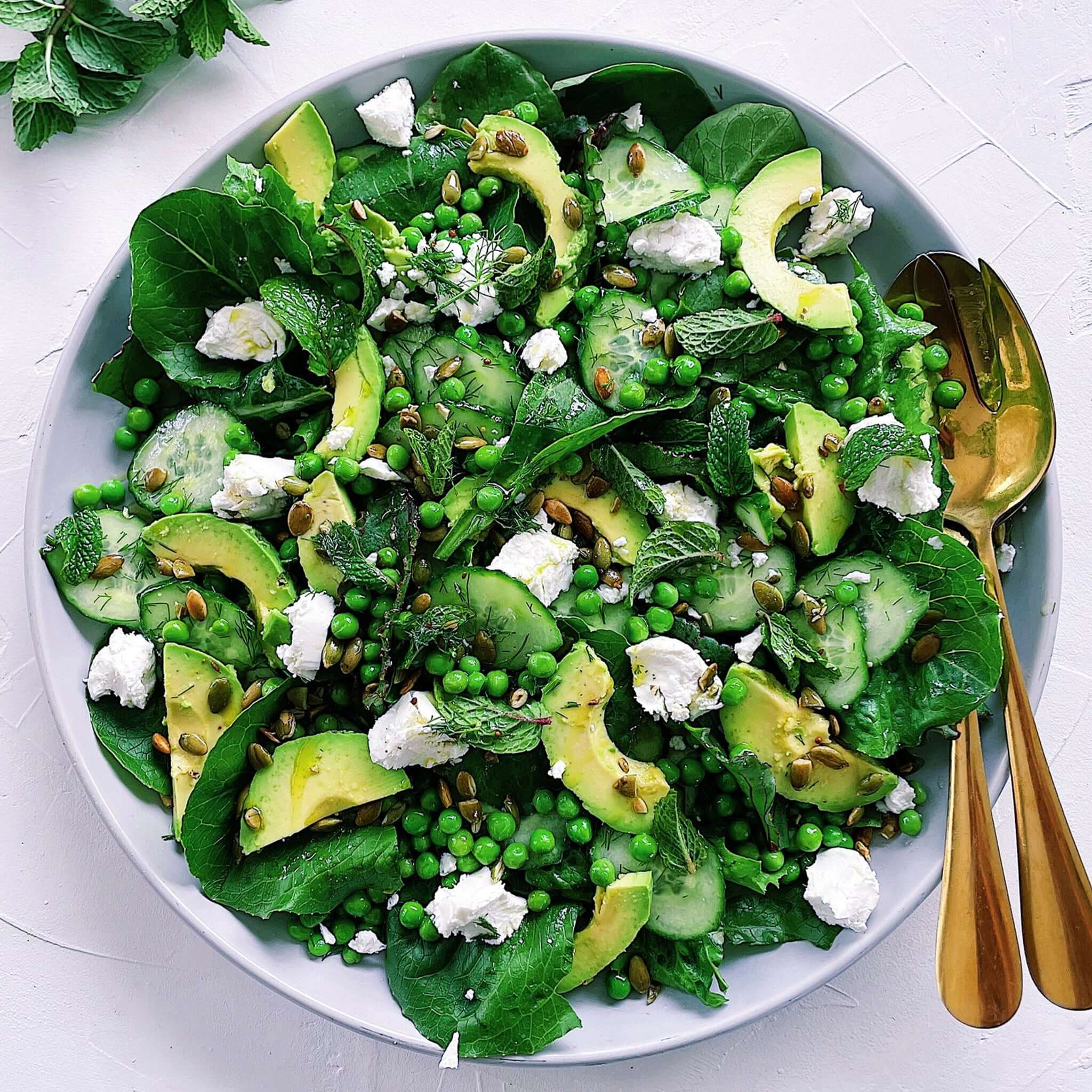 Alt Tag: Everything Salads: Spring & Summer cookbook featuring vibrant spring salad with avocado, peas, cucumber, spinach, feta and herbs