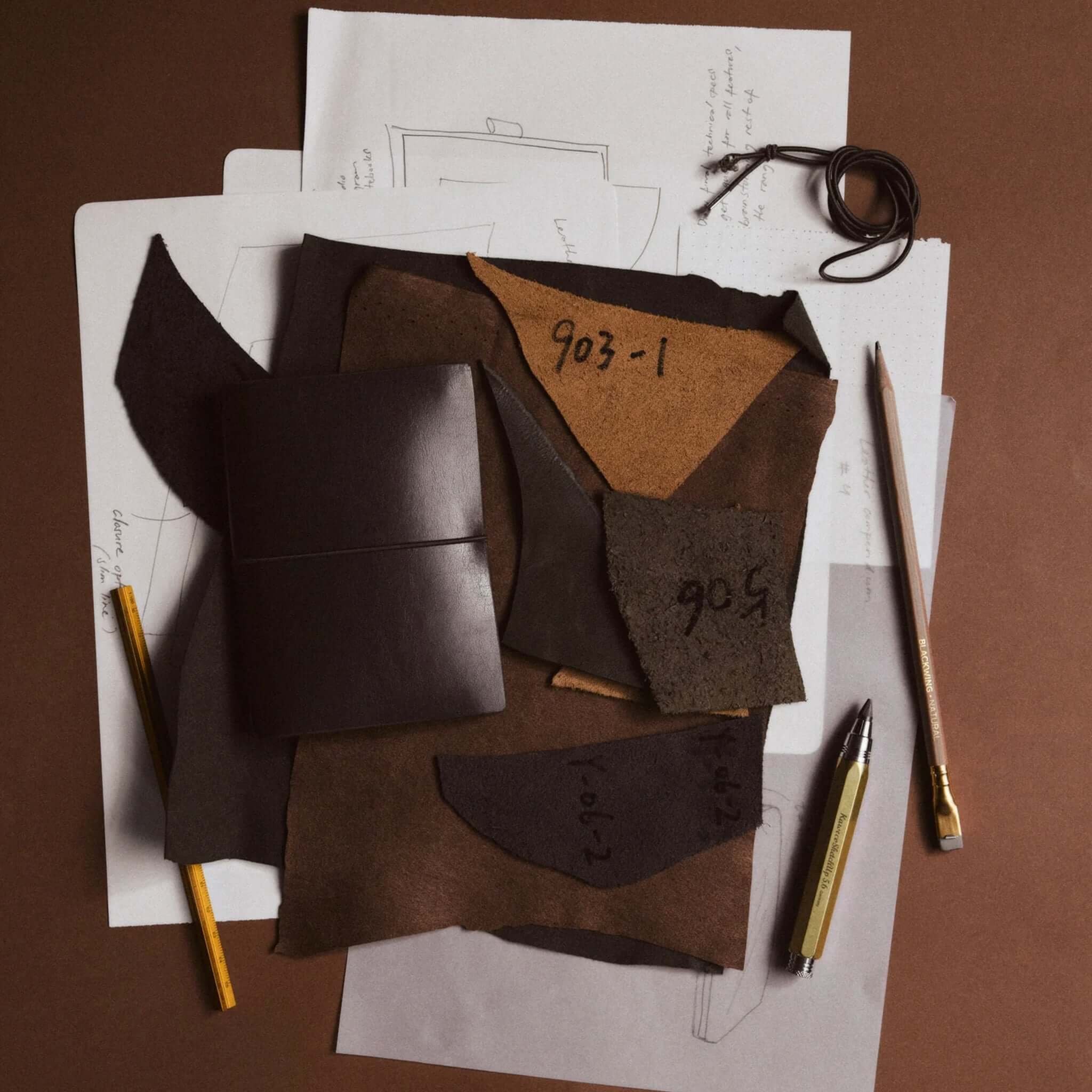 Milligram Recycled Leather Passport Journal Set - Chocolate alongside leather swatches and sketch notes.