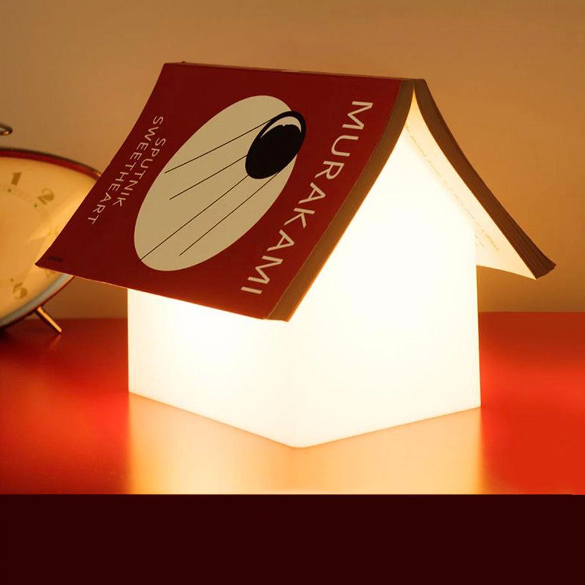 Book-shaped lamp with 'Murakami' on a red surface