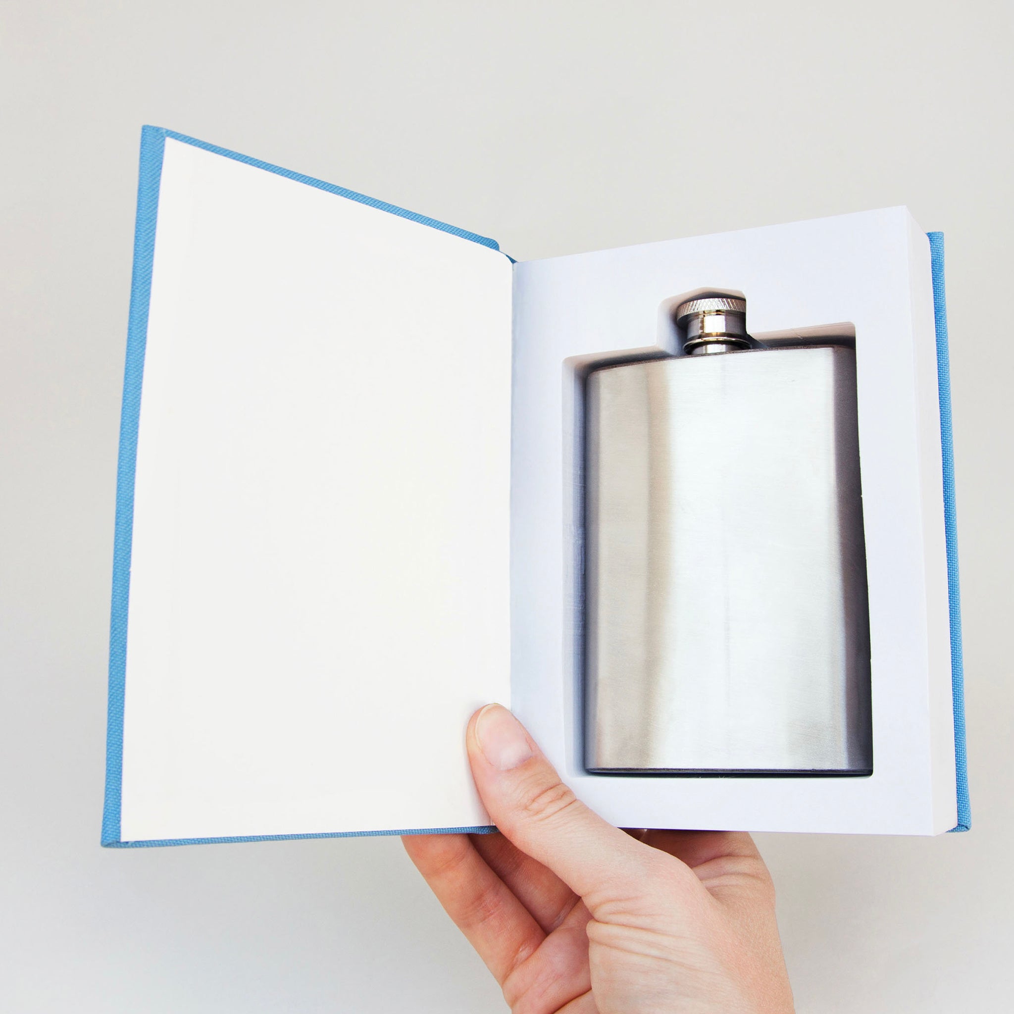 A hip flask in a self help book.