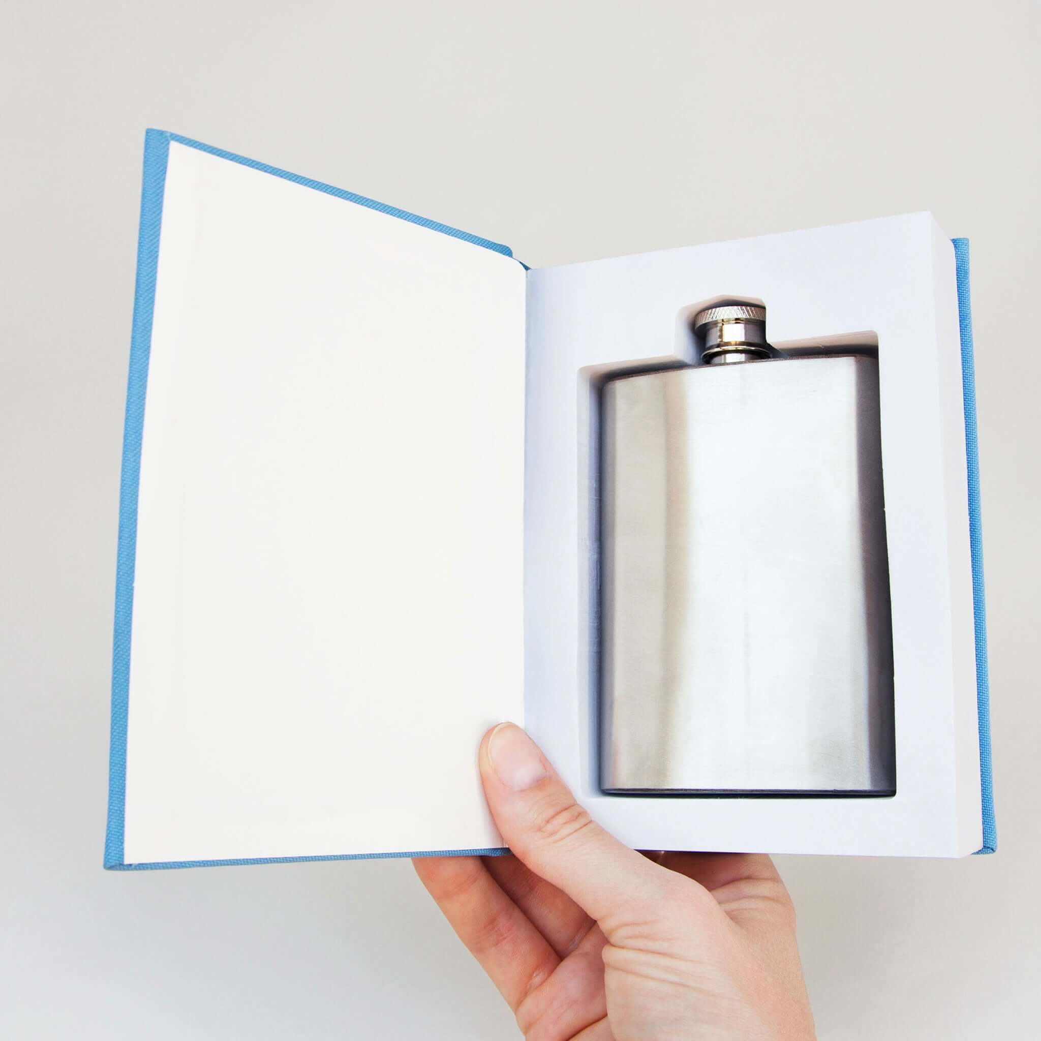 Alt Tag: Suck UK Flask in a Self Help Book hip flask hidden inside hardback book with paper pages, funny self-improvement gift